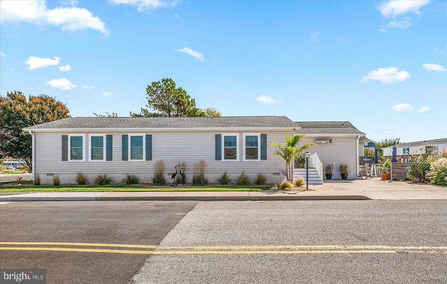 THE PERFECT BEACH GETAWAY! This Charming Beach Home Is Situated On A Large Corner Lot Beautifully Landscaped! At Dusk You Will Experience Garden Lighting That Warmly Illuminates The Exterior Of The Home & Flower Beds. Enjoy Warm Coastal Breezes & Sunday Summer Fireworks As You Lounge On The Spacious Private Patio. Home Is Tastefully Decorated & Comes Furnished With Only A Few Exclusions.  The Open Floor Plan Allows Entertaining Family & Friends A Delight! This Charming Beach Home Has 4 Bedrooms, W/A Large Sitting Room Off of The Master Bedroom, 2 Full Bath's & A Separate Laundry Room. Home Is Located A Short Distance To The Community Walking Path & Pond As Well As One Of The 2 Community Pools & A Fishing Pier. Other Amenities Include Tennis Courts, Shuffle Board & Mini Golf With NO CONDO FEES & A LOW HOA FEE, ONLY $396 PER YEAR! Walking Distance To North Side Park, Restaurants, Shopping & A Short Bike Ride To The Beach. Easy To Show & Priced To Sell!