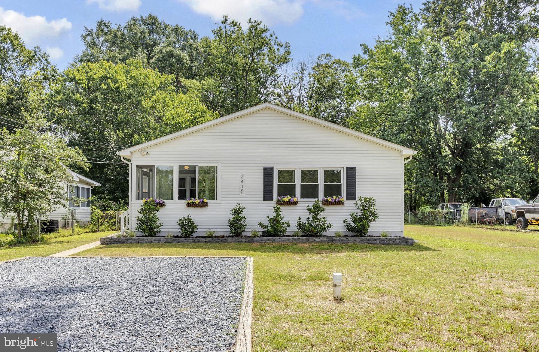 Welcome to 3415 Hazelwood Rd, a beautifully updated home in the desirable Hazelwood community. This recently remodeled 3-bedroom, 2-bath home sits on over half an acre, offering peaceful living with an open, inviting layout. Step into the charming 3-season sunroom, then into the bright living room filled with natural light. Around the corner, the modern gourmet eat-in kitchen features stainless steel appliances, white cabinetry, granite countertops, and a generous dining area perfect for gatherings. A second family room overlooks the backyard, providing even more space to relax and entertain. The primary suite offers a walk-in closet and private bath, while two additional bedrooms provide plenty of room for family or guests. An unfinished basement offers excellent storage and potential for a future build-out. Outside, enjoy the peaceful covered porch and paver patio, ideal for cookouts and summer evenings. Recent updates include 2025 paint and carpet, 2023 septic, 2022 water treatment system, HVAC, gourmet kitchen, and more. Located just minutes from marinas, rec areas, shopping, dining, and major commuter routes. ***A TRUE MUST SEE***