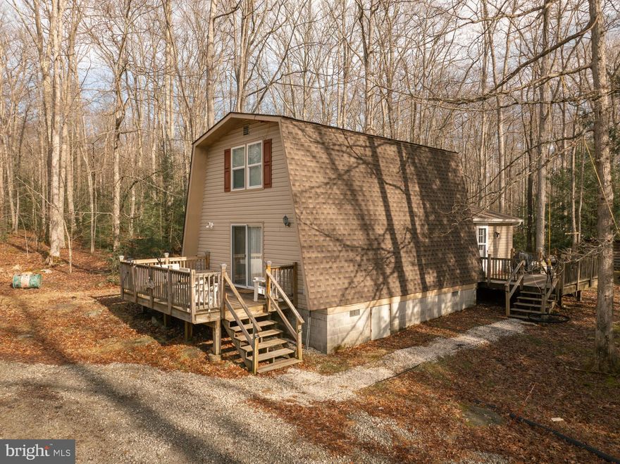 Thoughtfully remodeled and full of charm, this beautiful cabin offers 2 cozy bedrooms and 1.5 baths with an open-concept layout, laminated hardwood flooring throughout, an updated kitchen, and a spacious family room that instantly feels warm and welcoming. Whether you’re gathering inside or stepping out to enjoy the inviting hot tub, fire pit, and both a front and side deck, this home is made for relaxing, reconnecting, and creating memories. Two outbuildings provide plenty of storage, along with ample space for ATVs and outdoor gear. Surrounded by the peace and beauty of nature yet just a short drive to Deep Creek Lake, Swallow Falls, and endless outdoor adventure, this cabin is perfect as a joyful weekend escape or a full-time retreat in a community offering 50+ miles of ATV, snowmobile, and hiking trails, plus fishing, hunting areas, and more. This is cabin living at its best—come fall in love and schedule your showing today.