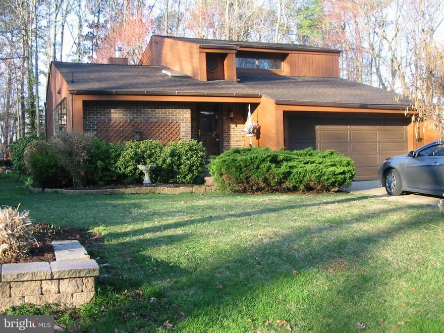 REDUCED! MOTIVATED SELLERS! Cedar & Brick Contemporary! Walk to the Chesapeake Bay! This home has recent updates; Roof Replacement, HVAC, Hot Wtr Heater & some Major Appliances. Open floorplan w/Cedar Cathedral Ceilings/Walls, Wood Floors, Brkfst Bar, Kitchen Garden Window & Sun Room w/Ceramic Floors leading to Outdoor Oasis; Deck, Lush Landscaping, Pond, Paver Walkways. Front Foot Paid & Low HOA!