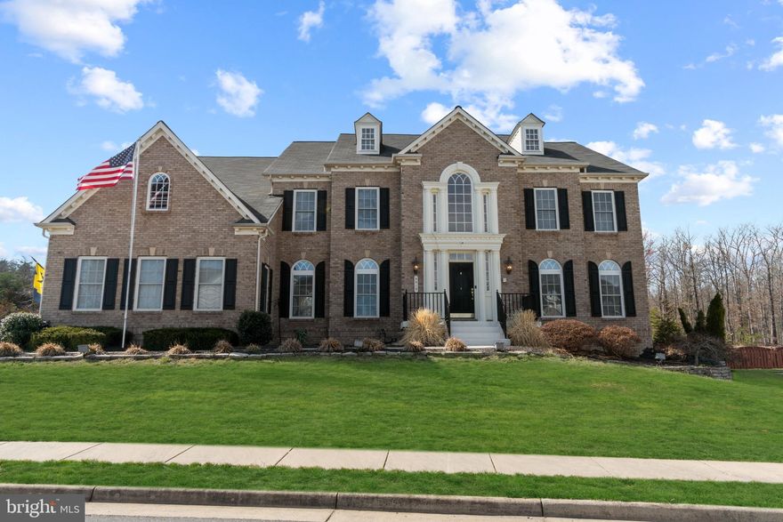 Wow- Gorgeous Brick front home in The Estates at Lees Parke!  Spacious Elegance awaits a new owner.  Two story Foyer with Dual Staircases, Formal Living Room & Dining Rooms, Main level Office, Two Story Family Room with Fireplace and Back Staircase, Huge Gourmet Kitchen, Light Filled Sunroom, 5 Bedrooms with ensuite Baths (5th bedroom lower level is NTC), finished basement with Huge Rec Room with Wet Bar, and so much more!  Custom Trim, Recently Remodeled Primary Bath, Large Deck, and much more on large corner Lot!  Super Location in Award Winning Community-