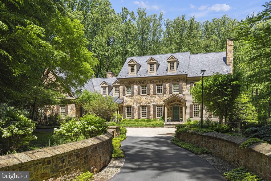 Nestled on a tree-lined one acre lot and surrounded by preserved woodlands in Avenel's coveted Eagle Ridge village, this custom-built center hall colonial showcases materials of the highest quality and superb craftsmanship. Mature trees and a lush natural landscape surround the private drive which includes a stone bridge that leads to the pea gravel courtyard. An elegant wood paneled foyer welcomes guests and provides access to the expansive formal living and dining rooms. The floorplan is gracious and has an effortless flow with all rooms stemming off of the classic center hallway.  The office/library with custom mahogany bookshelves and outdoor access through French doors enjoys a private setting just off of the grand staircase. The great room has three sets of floor to ceiling windows, a custom masonry fireplace and a ceiling with reclaimed wood beams leaving a striking architectural impression. The chef's kitchen features Smallbone English cabinetry, two functional islands, an AGA custom range and wine fridge and Subzero refrigerator. A breakfast area with views of the backyard, a fabulous screened-in porch with a built-in grill, mudroom with custom cabinetry, second powder room and garage with four car capacity round out the main level. Located on the upper level, the primary suite is a tranquil retreat complete with a den/office and a double-sided limestone fireplace. The newly renovated ensuite bathroom creates a spa-like atmosphere with twin vanities, oversized shower with multiple shower heads, dual water closets and freestanding tub. A large dressing room with extensive storage completes this luxurious escape. Four additional bedrooms each with ensuite bathrooms grace the upper level as does a generously proportioned laundry complete with a farmhouse sink. The lower level is an entertainer's haven with an expansive great room with a large stone fireplace. Custom stonework is found throughout this level which boasts a gym, billiards room, wet bar of reclaimed wood and a temperature-controlled wine storage room. A sixth bedroom with an ensuite bathroom, a large changing room/bathroom for the pool and a secondary laundry room complete the lower level which walks out to the extraordinary backyard. A freeform swimming pool with spa and waterfall feature is perfectly suited for the natural backdrop of the expansive yard with multiple patio areas. With a location just minutes to Washington, D.C. and access to all of the amenities that Avenel is known for, this exquisite home offers world class build quality in a setting with supreme privacy that is not to be missed.