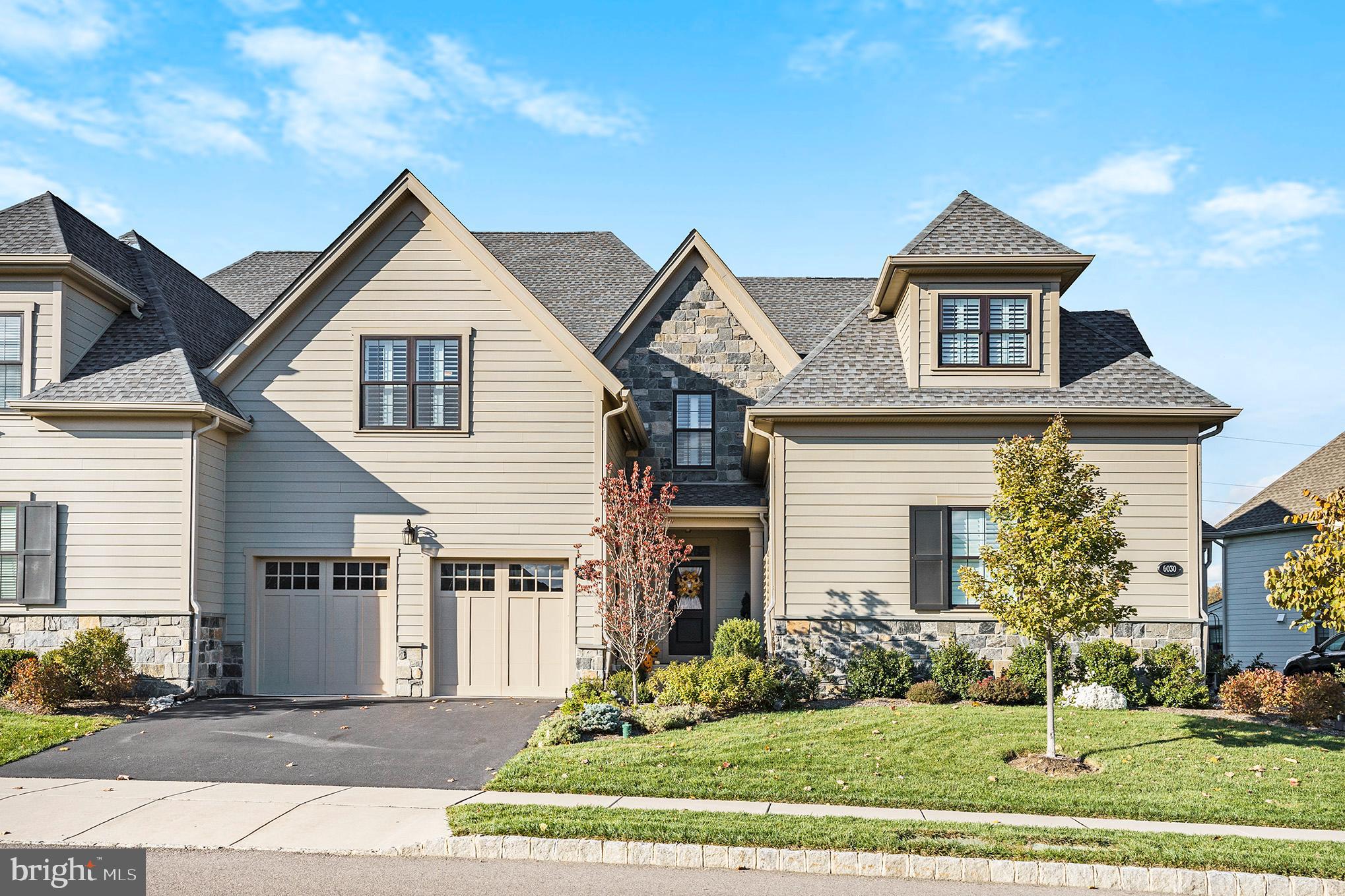 Welcome to luxury living at its finest in this stunning carriage home located in The Reserve at Creekside in Whitemarsh Township. This exquisite 3-bedroom, 2.5-bath Gowen model offers an unparalleled blend of elegance, comfort, and an enviable location. Boasting spacious interiors with high-end finishes, an open-concept layout and abundant natural light. The heart of the home is a chef’s kitchen, complete with a walk-in pantry, oversized island, gleaming plank wood flooring, premium quartz countertops, five burner gas cooktop and wall oven -perfect for culinary enthusiasts. A gas fireplace, nestled within a magnificent marble feature wall, anchors the living space, complemented by recessed lighting and custom millwork. Step outside to enjoy the private deck, ideal for relaxing or entertaining. This home offers three generously sized bedrooms, including a chic primary suite featuring designer walk-in closets and a spa-inspired ensuite with a large, glass-enclosed shower. Convenience is key with an upper-level laundry room. The unfinished full basement, with 9-foot ceilings, large egress window and pre-plumbed for a future bath, provides endless potential for customization, complemented by whole-house water filtration and softener systems. An attached two-car garage complete with a built-in car charging system, and spacious driveway ensure ample off-street parking. Perfectly positioned backing onto the 10th hole of the Philadelphia Cricket Club golf course—host of the 2025 Truist Championship, a PGA Tour Signature Event—this residence offers a front-row seat to world-class golf and a lifestyle of distinction. Enjoy access to premium community amenities like the Club House, pool and gym. This quiet neighborhood offers easy access to major roadways, Septa regional rail lines, fabulous shopping, restaurants and parks. Schedule your private tour today!