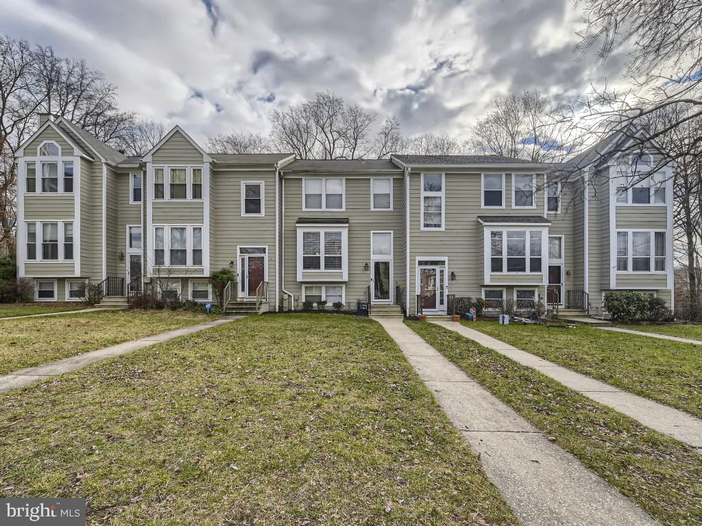 Come see this Beautiful Spacious townhome! The main floor boasts hardwood floors, large eat-in kitchen with granite countertops and stainless steel appliances, open concept dining and living areas with wood burning fireplace and sliding doors leading to deck with quiet wooded views. Upstairs you will find 3 bedrooms including a master suite with remodeled bath with glass surround shower, marbled floors and sink, and soaking tub. Walk-in closets and 2nd bathroom completes the upstairs. The basement adds an additional large living/recreation room, a 4th bedroom, and a full bath. Sliding door that lead out to a lower deck! Walking distance to The Woodlands Community Pool, Tennis Courts, and playground. Close to shopping, restaurants, and entertainment. For Commuting, Close to 100, 295, 95, Marc train, and BWI airport!