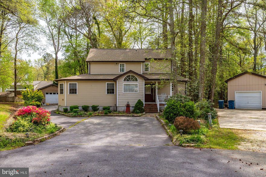 Welcome to 14 Trinity Place.   Located just inside South Ocean Pines at the end of a quiet cul de sac, this home features a spacious and functional layout with several living spaces and home offices.  Step inside to the family style kitchen with great lighting and ample cabinet space.  The kitchen was upgraded with stainless GE electric double oven range, LG side-by-side refrigerator and new dishwasher in 2024.   Hardwood floor flows from the dining room into the main living room with vaulted ceilings and wood burning stove.  Just off the living room and bright sunroom you have two sliding glass doors that connect you to the large, composite sun deck.  The impressive first-floor owner’s suite has so much to offer, featuring a walk-in closet, two attached office spaces and direct access to the back deck.  The primary bathroom boasts dual sink vanity, shower and jetted tub.  The home has seen several big updates, including a new roof installed in 2023 by Spicer Bros with a 30-year warranty, giving peace of mind for years to come. New HVAC installed in 2024, high-capacity Electrolux stacked washer and dryer in 2024 and new water heater in 2020. Upstairs features 2 freshly painted bedrooms with brand new carpet and a Jack and Jill bathroom.  Outside, enjoy a fully fenced backyard, detached shed, multiple driveway spaces and the convenience of a detached garage ideal for storage, hobbies, or extra parking. The surrounding trees create a serene setting, while the new composite deck offers a great space for relaxing or entertaining.  Located in amenity-rich Ocean Pines, residents enjoy access to pools, parks, beach club, golf, marinas, and more.  All this just a few miles from Ocean City. Don’t miss this move-in ready home with major updates already completed!