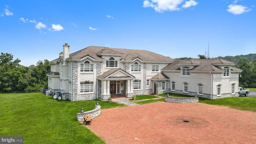 Forged upon a sprawling landscape of 29 acres within highly coveted Charlestown Township, rests this timeless family estate.  Located a stone’s throw from active equestrian farms, the grounds consist of expansive fields which accentuate the main house, featuring 11,682 SF of luxurious, yet functional, living space. Behold an amazing bonus: a 2-story, 3780 SF redeveloped barn featuring a full-court basketball court, full bathroom, and a professional woodcraftsman workshop on the lower level. This estate is the pinnacle of sophisticated, yet functional architecture.

Upon arrival through the main gated entrance, a tree-lined drive provides a breathtaking view of the grounds while welcoming you to your private sanctuary. Make your grand entrance into the majestic foyer, with its sight lines through to the back of the home and out onto the stone patio, and begin to absorb the beautiful design touches, including: an elegantly curved staircase, marvelous wood floor inlays with marble tile accents, entryways with wonderful arches, intricate millwork and crown moldings, stunning built-ins, and tray ceilings with cove lighting. Flanking the entry are the formal living and dining rooms. The living room boasts the first of two fireplaces on this level, as well as an accompanying piano room, while the dining room, with its built-in buffet and China cabinet, transitions to a butler’s pantry equipped with a sink and full-sized dishwasher. Well positioned at the left rear of the main level is the home office built for a mogul, wrapped in stately Cherrywood paneled walls. 

Moving through the main hall you will pass a secondary staircase, which provides unencumbered access from the basement level to the second-floor bedrooms. The spacious, yet cozy, family room awaits, which shares the second fireplace with the bright and expansive eat-in kitchen, where a wealth of windows, paired with the ample custom white cabinetry, create the sun-filled heart of this home. Seamlessly integrated appliances, dual refrigerators and wall ovens positioned around the large center island, and a walk-in pantry set the stage for serving up large family gatherings. This level is made complete with a bedroom; well-situated for a guest room or den, along with one full and one half bath, and a sizeable laundry room.

Make your way upstairs to discover the tranquil primary suite.  An oasis with soaring ceilings that leaves nothing to be desired. The bedroom provides a peaceful escape with amenities including a fireplace and a spa-like ensuite featuring a luxurious oversized tub, massive walk-in shower, private water closets, and radiant heated floors. This retreat is made complete with the privacy of two separate dressing rooms. Additionally this floor provides four well-appointed bedrooms, each with its own ensuite, also featuring radiant floor heating. For ultimate convenience, you will find the second laundry room strategically placed on this level.

The walkout basement, flooded with natural light, was designed for epic entertaining with a full wet bar, billiards room, recreation area, bonus room, and half bathroom. Stealing the attention on this level and adding to the allure of this estate, is a magnificent indoor pool just waiting to make lifelong memories year round. 

Additional features of this lovely estate include: a large bonus space with private stairway that can be finished for an in-law suite, an extended 3-car garage, an advanced water filtration system, 7 HVAC zones, a 100-year roof, lightening protection, and Smart Home protection, all ready to accommodate the vision of a discerning buyer.

Confidently invest in this paradise knowing the natural resources surrounding this refuge are protected, with over 80% of the township’s acreage being preserved. This property is subject to a conservation easement, which allows for expansion of the estate and other approved uses.