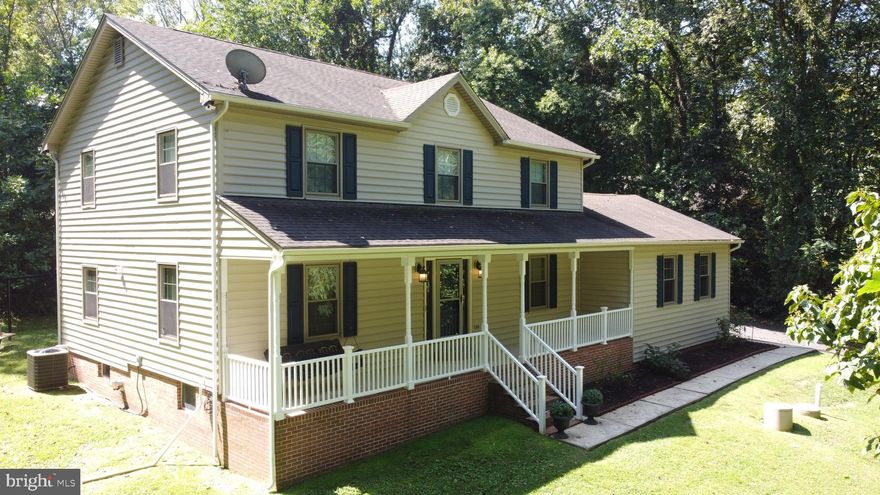 This charming Colonial home, renovated in 2017 with approximatley 230,000 worth of upgrades and improvements, offers a perfect blend of comfort and modern living, nestled on a serene 2.48-acre lot surrounded by lush trees and a gentle stream. The inviting exterior features a combination of brick and vinyl siding, complemented by a well-maintained gutter system and sidewalks that enhance curb appeal. Step inside to discover a spacious interior with 2,400 sq. ft. of thoughtfully designed living space. The open floor plan seamlessly connects the gourmet kitchen-complete with stainless steel appliances, a double oven, 2 dishwashers and a generous island-to the family room, making it ideal for gatherings. Enjoy the elegance of upgraded countertops and a butler's pantry, perfect for entertaining. The formal dining room and breakfast area provide additional dining options, while the cozy family room invites relaxation. Retreat to the primary suite featuring a luxurious soaking tub and walk-in shower, along with ample closet space. Three additional bedrooms and a partially finished basement offer flexibility for guests or hobbies. Outside, the expansive deck and porch provide a tranquil space to unwind and enjoy the picturesque views of the wooded surroundings. With an attached garage and a paved driveway accommodating multiple vehicles, convenience is at your fingertips. Located in a peaceful rural setting, this home is a true sanctuary, offering both privacy and the comforts of modern living. Experience the perfect blend of nature and home in this exceptional property.