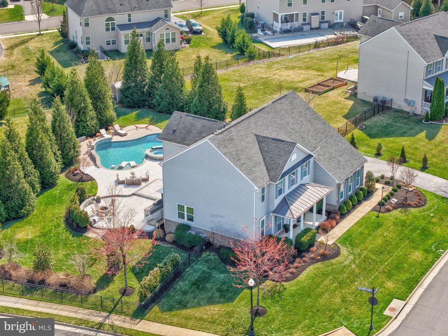 Beautifully updated home in the highly sought-after Dawson’s Corner community offering over 5,200 sq ft and $500K+ in upgrades. Resort-style backyard features a heated saltwater pool with fountains and LED lighting, 8-person hot tub, expansive multi-level patios, outdoor kitchen, fire pit, built-in speakers, patio TV, and a covered composite deck—perfect for entertaining.

The main level showcases a remodeled gourmet kitchen with oversized island, quartz countertops and backsplash, upgraded cabinetry, newer appliances (2025), and a bright breakfast area. Spacious family room with updated fireplace, plus formal living and dining rooms, private office, and upgraded mudroom. Hardwood flooring throughout the main level.

Upstairs offers a luxurious owner’s suite with sitting area, dual walk-in closets, and spa-like bath, along with three additional bedrooms, updated bathrooms, and a renovated laundry room with new washer/dryer (2025).

The finished walk-up basement includes a large rec room, theater room with projector and screen, built-ins, fireplace, full bath, and extra refrigerator.

Additional features include smart home upgrades (thermostats, lighting, security system), outdoor lighting, shed, fenced yard, and mature landscaping. Conveniently located near shopping, dining, major commuter routes, and Dulles Airport.