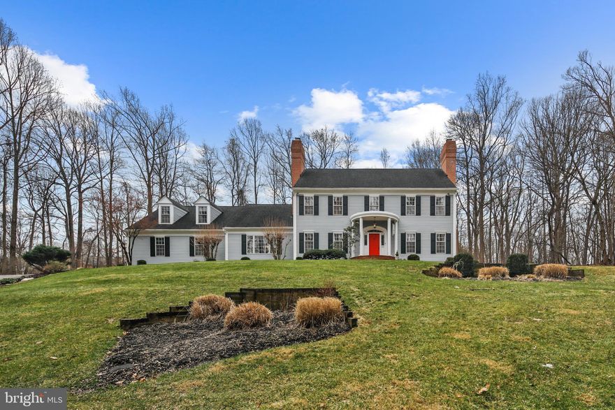 Pristinely sited atop a secluded 2.75-acre expanse, this five-bedroom, four full and one half-bath home in coveted Padonia Manor epitomizes a seamless blend of charm and sophistication. With an expanded two-car garage as well as an additional parking area and spanning 6577 square feet (4,401 square feet of above-ground living space), this residence achieves a perfect blend of timeless grace and modern convenience. Upon entering the grand two-story foyer complete with 9+ft ceilings throughout, a sense of sophistication and comfort pervades every inch of this stately home. The main level, adorned with three fireplaces and wood floors, is a testament to refined living. The chef's dine-in kitchen, featuring high-end stainless steel appliances and granite counters, is a culinary haven with an elegant touch. Adjacent to this, the family room delights with vaulted ceilings, a wet bar, and access to a sweeping three-season covered porch—a flawless setting for entertaining guests or unwinding with family. The main level further unfolds with a spacious guest suite boasting a full bath and a conveniently located mud/laundry room with a half bath, accompanied by a second staircase leading to an incredible 25 x 15 bonus/recreation room. Ascending to the upper level reveals four generously sized bedrooms and two recently updated baths, including the primary suite—a true oasis with a luxurious new over-sized shower, soaking tub, and a walk-in closet with ample storage. The expansive and partially finished lower level with walk-up, offers a generously proportioned space adaptable for many uses such as a home gym, recreation or game room, and features ample storage and workshop areas, complete with three HVAC zones. Outdoors, the residence extends its allure with the massive screened-in covered porch, deck, and patio, offering serene views of nature and abundant space for outdoor gatherings.  Recent updates include new baths, 2024 bedroom carpeting, fresh paint, 2023 stone walkways, rear stone patio, a whole-house UV water treatment system, and an EV electric car charger, that further enhances both comfort and convenience for the discerning homeowner. This meticulously crafted retreat is a rare find, presenting an irresistible combination of privacy, luxury, and modern living in the Falls Road corridor, and is convenient to shops, restaurants, excellent schools, and everything that Hunt Valley and Timonium have to offer.