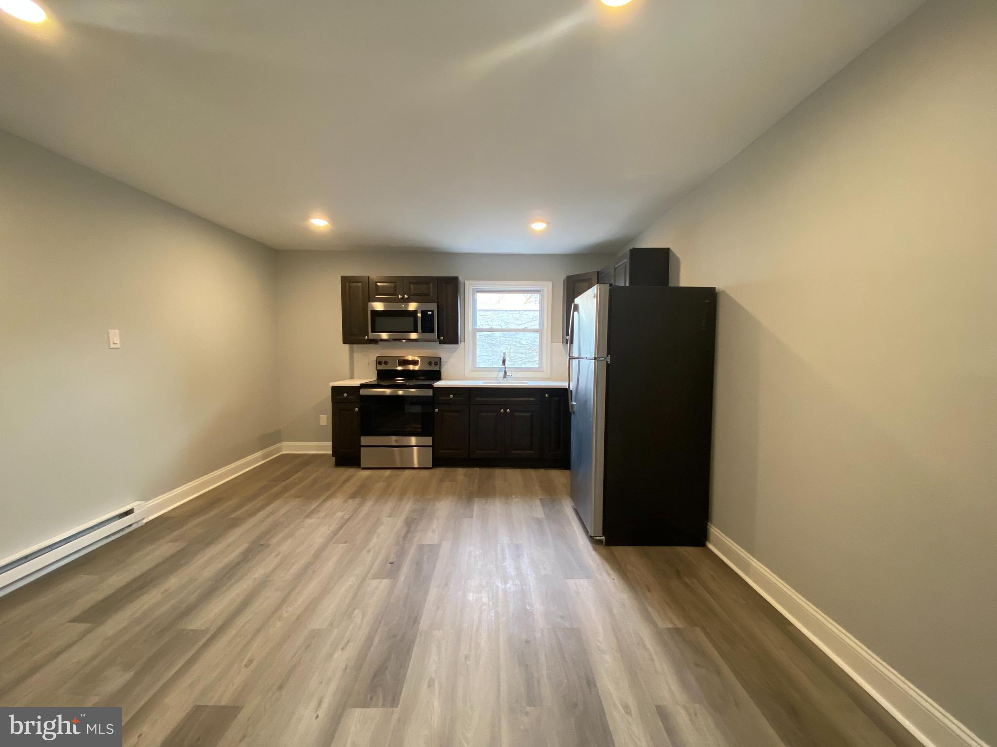 Step into your newly renovated one-bedroom, one bath apartment! This spacious unit features an upgraded kitchen with quartz countertops, dark gray shaker cabinets, white subway tile backsplash and stainless steel GE appliances. The bathroom showcases a brand new white vanity and tub with white subway tile. Other features include vinyl plank flooring throughout, keyless entry, electric heat and new windows and ceiling fan. $75 monthly water fee will cover all cold water usage. First, last, and security deposit required to move-in. Steps away from Vernon Park and a short walk to Uncle Bobbie's Coffee and Books, Planet Fitness, Walgreen and many restaurants, shops and markets. Located close to public transportation including the Germantown Train Stop and close to Germantown Friends School and Greene Street Friends School.