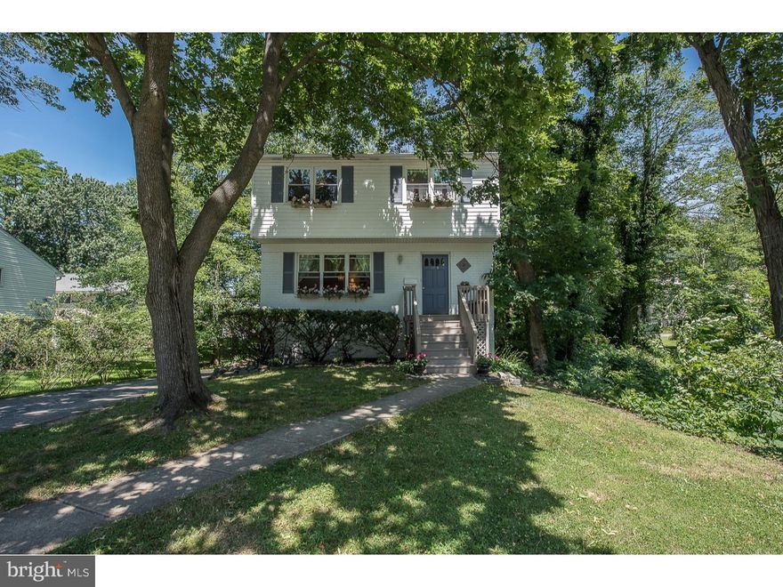 Unbelievable "walk-to" Wayne, parks, shops, farmers market location! This Charming Brick colonial is set on a quiet tree lined street. Lovingly maintained with a flexible floor plan the first level offers a Den/5th Bedroom with full bathroom and separate entrance. Entering the sun filled home you find beautiful hardwoods throughout the cozy living room which opens to the spacious dining room. The Eat-In Kitchen opens onto a deck perfect for BBQing, relaxing by the babbling brook overlooking the mature grounds. Upstairs you find a Master Bedroom with a large closet and half bath. 2 additional spacious bedrooms and a 4th bedroom/office. The Hall bath is updated and refreshed. The walk out lower level is a great playroom/movie room with plenty of storage and laundry room. The Lower Level opens onto a covered deck perfect for enjoying the backyard. Roof from 2006, newer windows throughout. Walk to two parks, restaurants, and so much more!