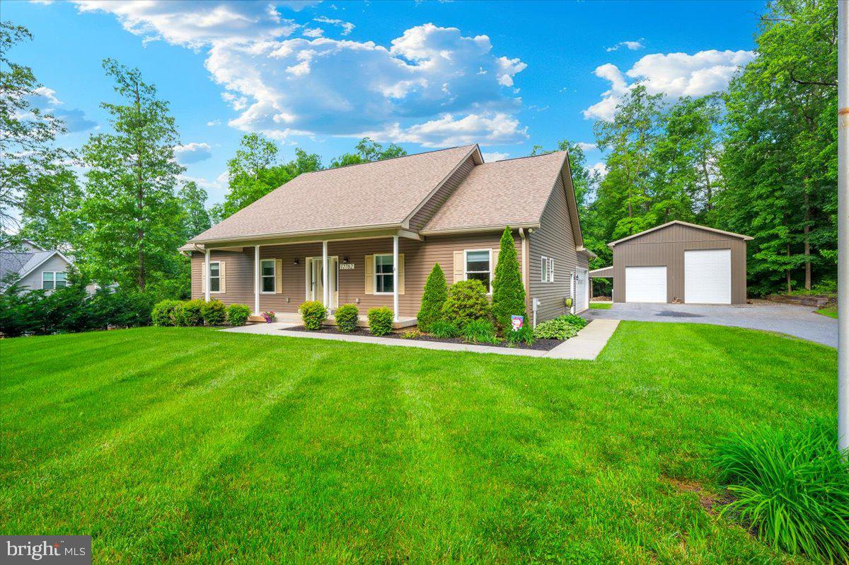 **Open house cancelled - property under contract**Welcome to this beautiful 3-bedroom, 2-bath custom rancher, perfectly situated on a spacious 1-acre lot. Designed with both comfort and functionality in mind, this home offers an open-concept layout with gorgeous hardwood flooring, built-ins, and a cozy gas fireplace that brings warmth and charm to the heart of the home. The kitchen features granite countertops, stainless steel appliances, a copper farmhouse sink, and rich hickory cabinetry. The generously sized primary bedroom is complete with an ensuite bathroom that offers a walk-in shower, soaking tub, dual custom vanities, and a walk-in closet enhanced with John Louis Home wood organizers. Thoughtful details continue throughout the home, including custom cabinetry in the bathrooms and laundry room, sliding barn doors, and a covered back patio - perfect for relaxing evenings or weekend gatherings. You'll also appreciate the spacious two-car attached garage with built-in shelving and sliding barn doors, plus an impressive 30x40 outbuilding with electric and a loft—perfect for a workshop, studio, or additional storage.The full, unfinished basement offers endless potential for future expansion or added storage. This home truly has it all - just move in and enjoy! See for yourself and schedule your private tour today!