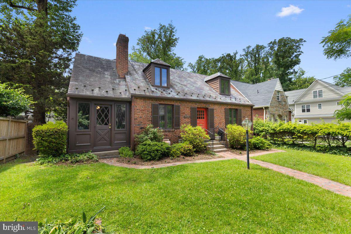Tucked in the heart of Bethesda, this charming brick English Tudor blends timeless character with thoughtful updates and a flexible layout to suit a variety of lifestyles. The main level welcomes you with a warm and inviting living room centered around a wood-burning fireplace. Just beyond, a quiet sunroom with its own entrance offers an ideal space for a home office or a peaceful reading retreat. The formal dining room leads to a dramatic, two-story eat-in kitchen—renovated with abundant cabinetry and anchored by a striking spiral staircase. The stairs rise to a lofted space beneath a dome ceiling, where skylights and tall windows bathe the room in natural light—perfect for morning coffee or a creative workspace. The kitchen opens to a beautifully
hardscaped courtyard and patio, overlooking the fully enclosed rear yard—perfect for al fresco dining and entertaining. Also on the main level: a front bedroom and a sunlit flexible room—currently staged as a second bedroom—with a pitched ceiling, walls of windows, and access to the rear porch and yard. Paired with an adjacent updated full bath with a walk-in shower and a nearby den or library with custom built-ins that could be converted into a walk-in closet, this area presents an wonderful opportunity to create a main-level primary suite. Upstairs, you’ll find a spacious primary bedroom with an ensuite bath, along with an additional bedroom. The finished lower level provides even more living space with exterior access, featuring a playroom, bonus room, half bath, utility area, and ample storage. Additional highlights include off-street parking, mature landscaping, and a private, fenced backyard. Located just 1.6 miles from Bethesda Metro and close to the NIH campus, this home offers easy access to top-rated schools, parks, shops, dining, and everything that makes Bethesda such a vibrant and sought-after community. A rare find that combines charm, flexibility, and location—don’t miss it!