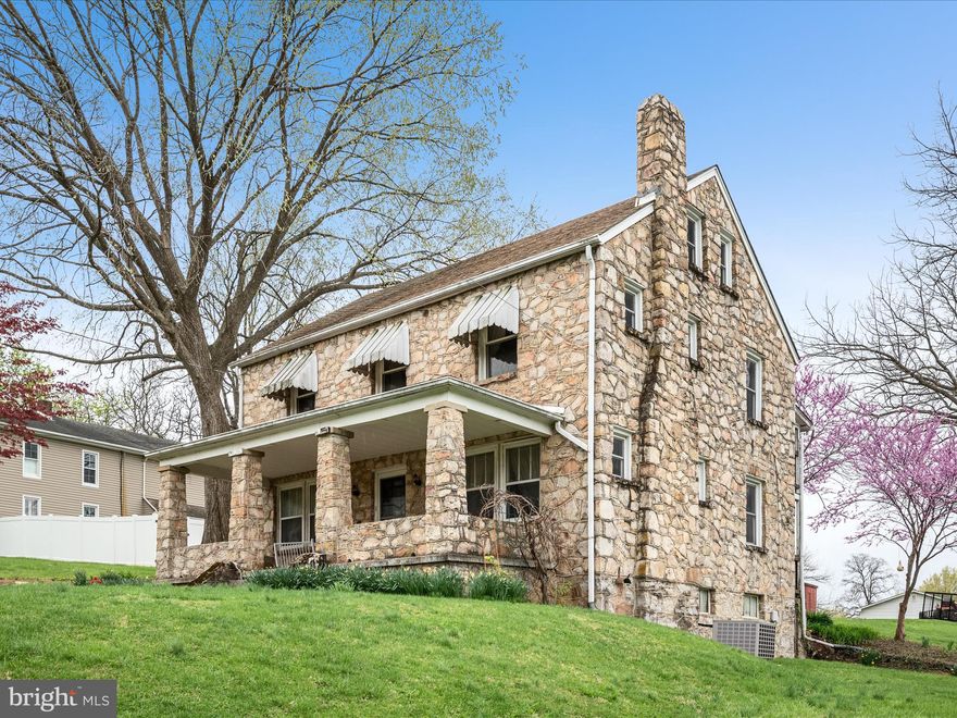 Price Reduced.....This beautifully crafted stone estate is bursting with character and sits proudly on nearly a 1/2 acre lot in town offering space, serenity, and a serious porch game....Yes, multiple covered porches because one just isn't enough. The classic red barn adds incredible charm plus provides room for all your hobbies or a studio.  
This home just keeps going once you walk inside and explore all 4 levels! There are 4 spacious bedrooms and 2 bathrooms plus a partial finished attic area with potential for 2 more rooms. They just don't build them like this anymore! This property is more than just a home it is a sanctuary.