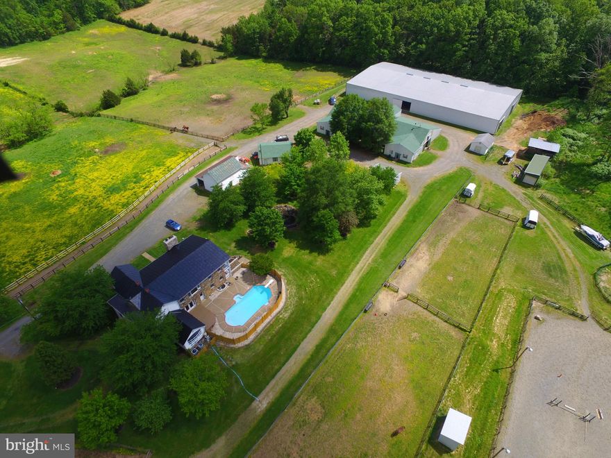 If your dream is to run your own EQUESTRIAN facility, here's your opportunity to do what you love and make money.   Included is a 27 stall barn with a one bedroom apartment, an additional 15 stalls in various sheds/barns,  a 122 X 175 indoor arena built in 2011,  a large outdoor arena, round pen, ample storage and numerous pastures with auto waterers. a gorgeous spring fed pond, 3 bay garage, a spacious 6 BR, 4 .5 BA home, a pool, koi pond, and a gated driveway make this a great property to run your equestrian business or simply use for personal enjoyment.    Sold strictly AS-IS.  Lovely setting and totally useable.  The property is situated on 27.8 acres, located in PW County, with approximately  2 AC located in Fauquier County.
