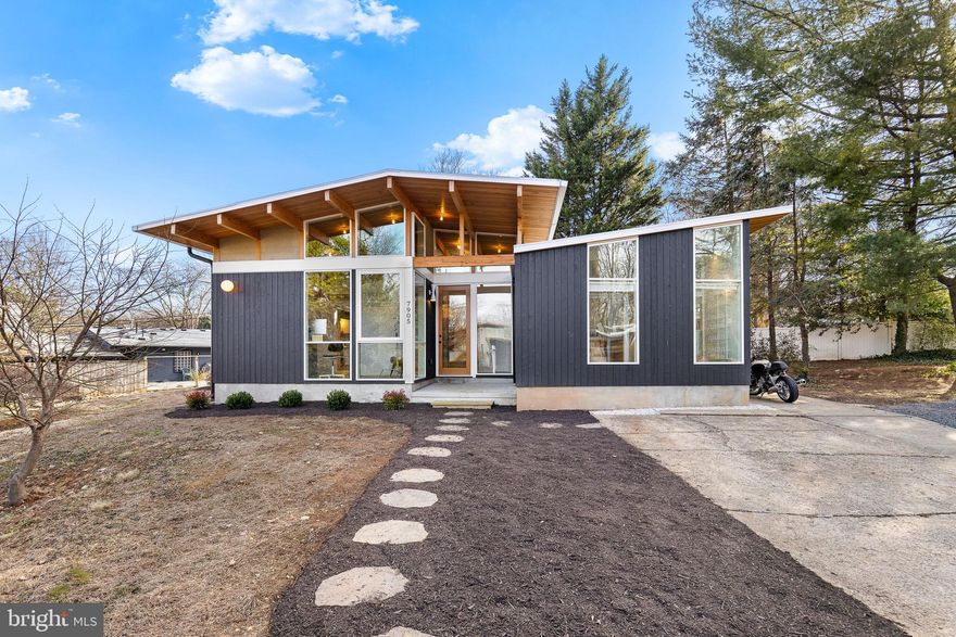 NEW PRICE! - Holmes Run Acres, Stunning Mid-Century Modern Reno! Experience the timeless elegance of this mid-century modern home fully remodeled by Michael Cook Architecture. Nestled on nearly 1/3 acre on a cul-de-sac, this one-level home seamlessly blends sophisticated design with modern functionality. Walls of oversized windows bathe the interior in natural light, blurring the line between indoors and out. New wide plank white oak flooring and Douglas Fir cathedral beamed ceilings span the entire home. The spacious open kitchen features a large center island, Poggenpohl cabinets, handmade Heath Ceramic tiles, premium appliances and built-in seating. The French door in the kitchen opens to private deck. The kitchen flows into the open dining and living room highlighted by the wood burning fireplace. Two ensuite bedrooms boast stunningly designed baths featuring custom ash wood vanities, Dutch Mosa tiles, and Elfa closets offering ample storage. The third bedroom also functions as a versatile family room, with a built-in bar area, an attached half-bath, and a conveniently located laundry space. A dedicated office/den with a built-in desk provides a stylish and functional workspace. Every corner of this home is a showcase of high-end finishes and designer touches. The home is clad in Shou Sugi Ban Japanese cypress siding, and the deck features TimberTech decking.  The slate-style rear patio overlooking the landscaped yard. Conveniently located minutes to INOVA Fairfax, the Mosaic District, and Tysons Corner. Offers easy access to commuter routes (Routes 495, 66, and 50). This home is a true masterpiece, offering mid-century modern charm reimagined for today’s lifestyle.