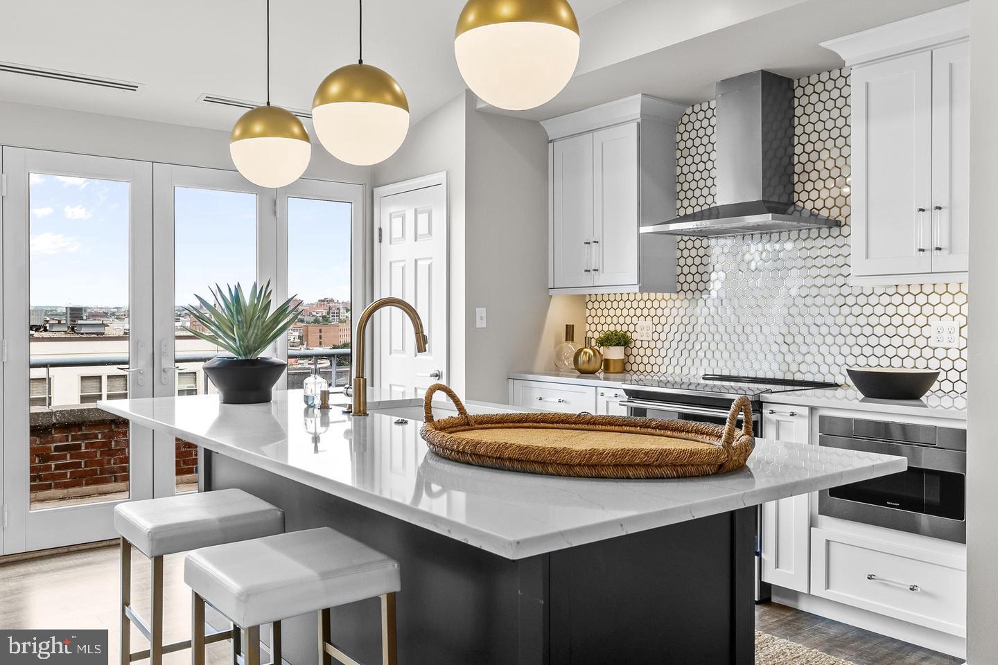 Sophisticated Two-Level Penthouse at Henderson’s Wharf – Waterfront Living at Its Finest Welcome to a truly exceptional residence in the heart of historic Fells Point. This one-of-a-kind, luxurious two-level penthouse at Henderson’s Wharf offers a rare combination of elegance and comfort, perfectly positioned along Baltimore’s coveted waterfront. Designed to capture natural light and sweeping vistas, the home features two private balconies: one with views of the harbor, where boats and water taxis glide by, and another overlooking a peaceful, landscaped courtyard. Floor-to-ceiling tinted balcony doors enhance privacy and energy efficiency while framing the scenic surroundings. Inside, the main level offers an open-concept layout with timeless design details, including rich, prefinished hardwood and a calming neutral palette. The kitchen is both stylish and functional, featuring white cabinetry, quartz countertops, sleek appliances, a center island, and clever storage with pull-out drawers. The adjacent living and dining area is anchored by a vaulted ceiling and a wood-burning fireplace, creating an inviting space for both relaxation and entertaining. Smartly placed charging outlets throughout the home offer modern convenience for all your devices. Lots of attention to detail throughout this home The first-floor primary suite is a serene retreat, featuring a charming brick accent wall, double custom-designed closet systems tailored for both function and elegance, and a spacious en-suite bath with a double vanity and a beautifully tiled walk-in shower. Additional conveniences on this level include a powder room and a full-size washer and dryer. A deeded garage parking space ensures effortless city living, while the location—tucked away on a quiet cobblestone street—puts you just moments from Fells Point’s vibrant cafes, restaurants, boutiques, and waterfront attractions. This one-of-a-kind penthouse is the perfect blend of luxury and lifestyle. Don’t miss the opportunity to call this waterfront gem your home—schedule your private showing today.