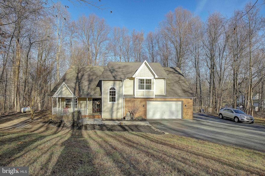 Lovely Colonial/Cape being offered for sale offering so many great features. Nicely situated on a 2 acre parcel in The Willows gives you the privacy of the 2 acres and the use of the community features which include the beach access to the Chesapeake Bay. This home has been recently painted, new carpet, deck updated and new boards and railings and more. Offering stunning vaulted ceilings and wood floors as well on the main level. The very large kitchen has a plenty of cabinet space and offers a large island perfect for everyday and entertaining. the built in pantry and space for a table will make you fall in love with this space and what it has to offer. The great room is just off of the kitchen and is large and open. The natural light gleams in and allows for a warm cozy feel next to the wood burning fireplace. There is a dining room being used as a reading nook and easily could be used for your dining table and guests. This space is very flexible and open. One the main level there are 2 bedrooms both good sized with an adjoining bathroom.  On the upper level it offers you a Primary bedroom which is huge with an abundance of closet space between 2 walk-in closets. A nice primary bathroom with a separate shower and tub. The second bedroom on the upper level is a nice size and has a large walk-in closet as well. There is a place that an on-suite bathroom could be added to make this a private suite as well or use the entire upper level for your primary suite!  The basement is unfinished and very open. Equipped with a rough-in for a full bathroom and is walkout level. The large deck is just another feature that offers great outdoor space for warm weather activities and the views of the woods are delightful. 2 acres of privacy is perfect for your family.  Voluntary HOA $200 a year is for the community to maintain the beach and water access. This home does have water rights as it is in The Willows. Roof to be replaced so there will be a new roof as well. The HVAC and water heater are newer as well. Nice location and great home come check it out and bring us an offer! You will not be disappointed.  Fireplace is as-is. Has not been used in a long time as far as the owner knows it is in working condition.