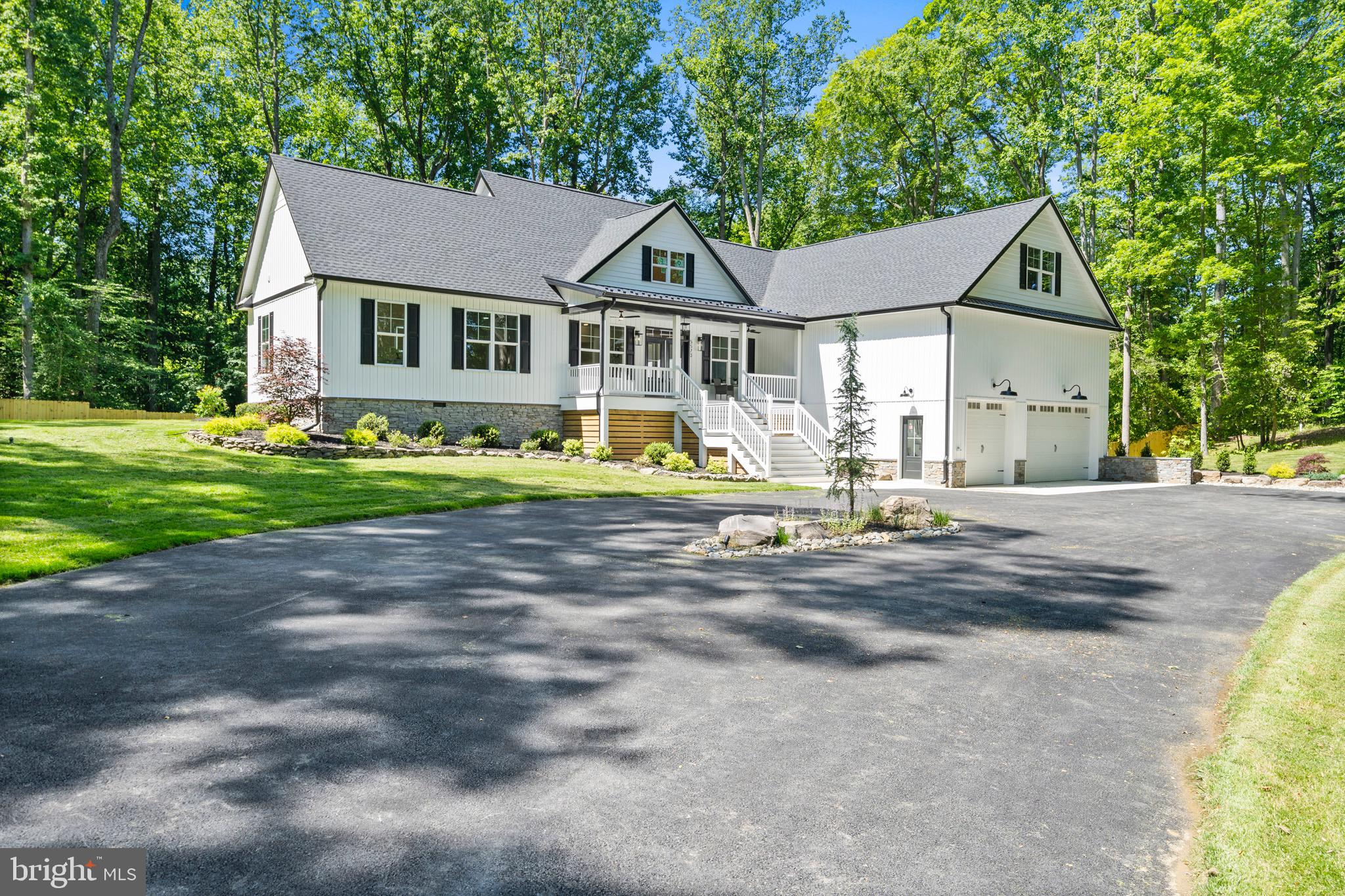 BACK ON THE MARKET! YOU DIDN'T MISS OUT! (Buyer didn't meet home sale contingency. Home Inspection in hand- save $!) Luxury New Construction Retreat on a Wooded Lot.
Discover refined living in this brand-new luxury home, perfectly situated on a private wooded lot in one of the region’s most desirable locations—just a short drive from Annapolis and Washington, DC. This home blends modern luxury, natural beauty, and everyday functionality in a location that offers both tranquility and convenience.
This thoughtfully designed residence features 4 spacious bedrooms, 3 of which boast their own en suite bathroom and walk-in closet, offering comfort and privacy for every member of the household.
The heart of the home is a gourmet kitchen that will delight any chef, complete with high-end quartz countertops, GE Café appliances, a built in drawer microwave, a massive island ideal for cooking and entertaining, perfectly located slide out trash cans, and a wine refrigerator.
Retreat to the primary suite, where a custom walk-in shower with a rainfall shower head creates a spa-like experience. The suite offers a large walk in closet and private deck.
Additional highlights include:
UV light filter system installed on the well water system.
Whole house HEPA air filter to help manage environmental allergens.
A huge 3-car garage complete with 9 ft garage doors, Garage parking includes an E.V. charger and dedicated workshop space—perfect for hobbyists or extra storage. Includes 2 dehumidifiers installed in garage and workshop.
A large finished room over the garage, ideal as a sports lounge, teen hangout, or additional bedroom.
A dedicated home office, perfect for remote work or study.
Two expansive back decks offering peaceful views of the surrounding woods—ideal for morning coffee or evening relaxation.