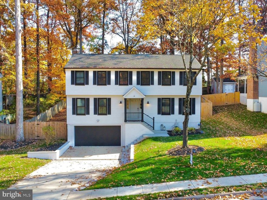 Step inside this gorgeously renovated 3-level single-family home in Herndon! Exceptional curb appeal is provided by the large black windows that adorn the facade of the house and create a bold and dramatic contrast to the white siding. This expansive 5-bedroom,  2.5-bathroom home, features neutral paint colors, luxury vinyl-plank floors, and recess smart lighting throughout the main level. The living room opens into a cozy fireplace that will create a great ambiance and provide a gathering place for family and friends. The adjacent sliding glass door opens to the fully fenced yard allowing for indoor-outdoor living. The open concept kitchen is beautifully designed with quartz countertops, brushed gold hardware, and two-tone cabinets. Vertical black tile and open shelves generate a stylish focal point in the kitchen. The half bath on the main level also serves as the laundry room. Folding doors conceal the front loading washer and dryer as well as a laundry chute and cabinetry to keep the folding station tidy and keep laundry supplies out of sight.  Venture downstairs into the fully finished basement with new carpet that acts as a bonus room and has direct access to the oversized 2-car garage. The upper level boasts a large primary bedroom and a sizeable en suite spa-like bathroom. The primary bath enjoys an abundance of natural light, a double vanity, a frameless dual-shower head shower, and access to a walk-in closet with a custom closet organizer system. Four additional, generously sized bedrooms share a lovely guest bathroom complete with a glass bathtub door, oversized tile, and trendy black hardware. Equipped with Samsung smart appliances, you'll be able to monitor and control them right from a phone, Google Home or Amazon Alexa. Updates include, HVAC (2022), windows (2023), garage door (2023), LVP (2023), EV charger. Located less than two miles from Herndon's historic downtown district you will enjoy access to the railroad depot, walking tours, parks, galleries, museums and weekly farmers market. Just a 10 minute drive to the shopping and dining of the Reston Town Center and less than 5 miles to the metro. Easy commuting options with Fairfax County Parkway, Routes 7, 28 & 267. Dulles International Airport less than 10 miles.