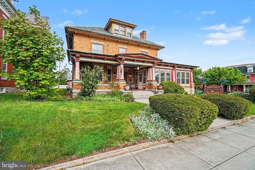 Welcome to Walton Manor Bed & Breakfast, a stunning historic property located on a prominent corner lot in the heart of Palmyra. Offering nearly 6,000 square feet of charm and character, this beautifully maintained home combines timeless elegance with modern updates, making it an exceptional opportunity for an established bed & breakfast or unique residential retreat.

Inside, you’ll find gorgeous hardwood floors, five spacious bedrooms, four full bathrooms, and a convenient half bath on the main level. The home features expansive gathering spaces perfect for entertaining guests, relaxing with family, or hosting special events. A private laundry room adds everyday convenience. For added guest comfort, the home has been updated with mini-split units in each bedroom, allowing for personalized climate control throughout the property. The home also features two separate staircases, allowing for convenient and quiet access between floors.

The third-floor apartment offers incredible flexibility with its own private entrance, bedroom, kitchen, and full bathroom — ideal for owner accommodations, extended stays, or additional rental income.

Guest bathrooms have been tastefully updated with tile flooring, tiled showers, and sleek glass sliding doors. The basement includes a workshop and multiple storage rooms, providing plenty of functional space for business operations or personal use.

Outside, the original carriage house serves as the perfect garage for additional storage or covered parking. The property features four paved parking spaces along with two covered parking spaces located in front of the garage for added convenience.

The sale includes all furnishings, artwork, appliances, linens, and dining ware, allowing for a truly turnkey opportunity.

Showings are best accommodated midweek. Contact us today to schedule your private tour of this one-of-a-kind property!