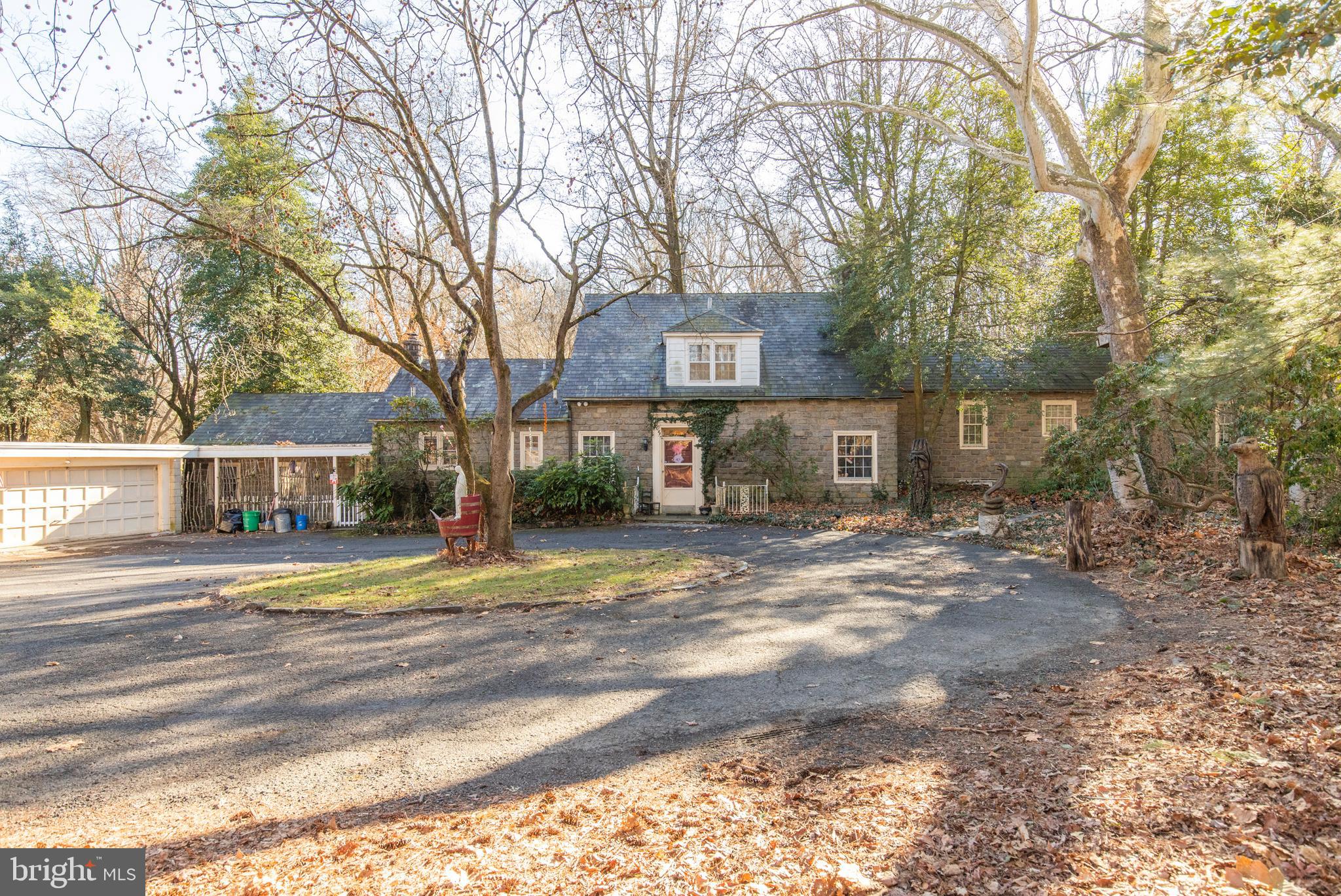 Stately stone cape situated on an expansive corner lot in Fox Chase. The ultimate in social distancing, yet still great proximity to all conveniences. House has been well cared for and has a rich history. Enter in to the foyer, on your right is a large welcoming formal living room with fireplace. Impressive wide plank oak flooring flows throughout the house. Warm formal dining room overlooks a picturesque rear yard. Kitchen could use updating but is well equipped. Entertain guests in the cozy parlor with bar and convenient power room. Covered back porch overlooks your own scenic park. Up a few steps to the next level you will find a study, full bath and master bedroom with fireplace. Up through a unique turned oak staircase and you will find 2 additional bedrooms and another full bath. Bedrooms have abundant storage and cedar closet and lots of bonus space. Back downstairs off the kitchen are 2 additional bedrooms as well as a laundry area. This area could serve as an in law suite, home based business or whatever purpose to suit your requirements. The yard photos speak for themselves with large acreage and peaceful setting. Also outside is plenty of parking, a 3 car garage as well as a separate workshop with garage door entrance and electric, perfect for car enthusiast or a contractor. The seller asking price is for the house and the land. They are open to any offers to buy all as is, or would also consider a subdivide arrangement. See Land listing at MLS# PAPH866248. Make an appointment to check out this impressive one of a kind property.
