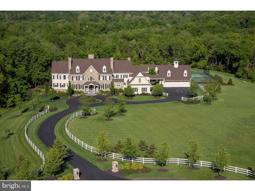 Welcome to Stonebridge Manor, a 32.34 acre estate perched high on a hill with dramatic, breathtaking views of historic Bucks County and the rolling vistas of New Jersey. This exquisite property sits majestically in a cul-de-sac within an enclave of nine other custom estate homes. The long, beautifully landscaped, curved driveway circles in front of the residence and leads to the main entrance. Inside, the foyer is two stories in height and features custom mill work, crown moldings, built-in lighted book/display cases and custom chandelier. It is hard to decide where to spend time on the first floor of this magnificent home. There is the formal living room with gorgeous millwork & marble surround gas fireplace, casual living room with stone gas fireplace & doors which lead to a mahogany ceiling covered porch with wood burning fireplace, or the hearth room with a cherry mantle stone fireplace & windows overlooking the blue flagstone terrace, pool and pergola. As in most homes, the kitchen area is where much time is spent! The Signature kitchen in Stonebridge Manor has a 9'x5' granite island, tumbled marble backsplash with custom mural, TWO Sub-Zero refrigerators/freezers, Wolf gas cooktop with copper hood, Villeroy & Boch sink, Dacor warming drawer & 2 Asko dishwashers. Adjacent the kitchen is a beautiful breakfast room with stone wall, vaulted ceiling, heated floors, arched wood/stone openings & a wall of windows overlooking the pool and sunrise in NJ. Speaking of views, every window you look out is like looking at a different scene from a movie! The enormous first floor study has its own sun drenched sitting room, separate front entrance, wet bar, full bath and guest suite which can also work well as Au pair quarters. Upstairs is the master suite with opulent master bathroom, reading room and an spectacular sitting area offering vaulted beamed ceiling, marble gas fireplace, built-ins and doors to large roof deck over looking the pool. Three additional bedrooms(all en-suite), bonus room & 2nd laundry room complete the 2nd level. The w/o lower level has 10' ceilings, stone fireplace, full kitchen, game area, theatre & gym. An elevator services all 3 floors. Outside are magnificent terraces, patios, pool, pool house with kitchen, vaulted ceiling, bathroom & laundry. Sliders open to the pool and tennis court. 6 car garage with rough-in for 1 bedroom apartment above. Great trails for hiking. Separate approved 10 acre building lot included. Council Rock Schools.