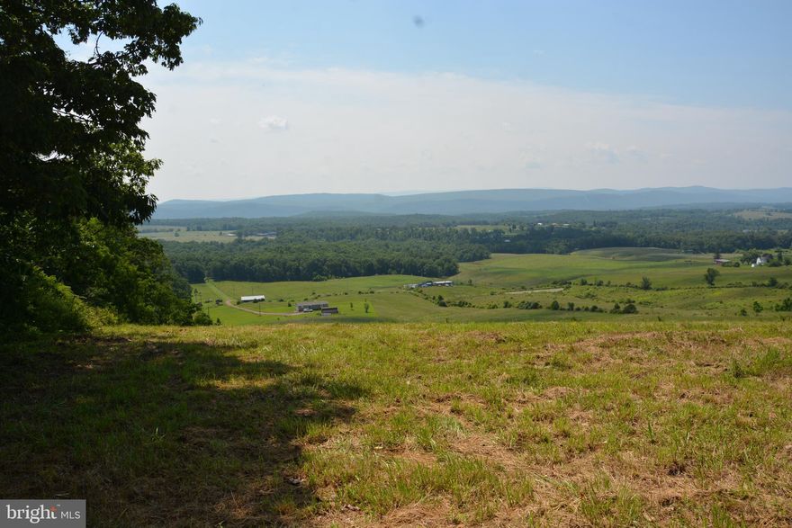 Beautiful piece of land with amazing 180d views. All cleared pastureland, slight upgrade until you get the the rear of the land, then steeper grade takes you to the "top of the world". No covenants or restrictions. Surrounded by farmland. Backs to dense forest. This peaceful setting is perfect for your custom Log Home or large Chalet, overlooking your horse or cattle pastures. Minutes from the Slanesville Post Office & store. Must see up close and personal to appreciate the long-range views.