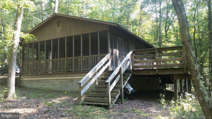 Enchanting Cabin in the Woods, Cacapon River Access, 2.34 acres, Large deck & screen porch, Recent Renovation - 2 bedrooms 1 bth, Open floor plan, Wood Stove, Heat Pump, Newer roof. Custom Kitchen, New Appliances, Large windows. This ones ready to enjoy, Relax on your deck having a cook out or venture out on the Cacapon and discover the miles of this fascinating water way with all it has to offer.