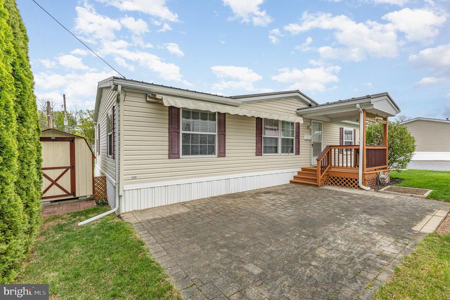 Welcome! This charming 3-bedroom, 2-bathroom manufactured residence, built in 2008, offers a perfect blend of comfort and style. The spacious layout features a main floor laundry for your convenience, making daily chores a breeze. The heart of the home is the well-appointed kitchen, equipped with essential appliances including a gas oven/range, dishwasher, and microwave. Step outside to discover delightful exterior features, including a welcoming porch and a lovely paver patio, perfect for enjoying your morning coffee or evening relaxation. The property is adorned with a retractable awning to shade the patio while hanging out on those sunny days!  Roof is less than 5 years old! Storage shed offers ample space for your belongings. Parking is also hassle-free with plenty of on-street options available. Located in a friendly community, this property is ready for you to make it your own. Schedule your visit today and experience the comfort and convenience this property has to offer!