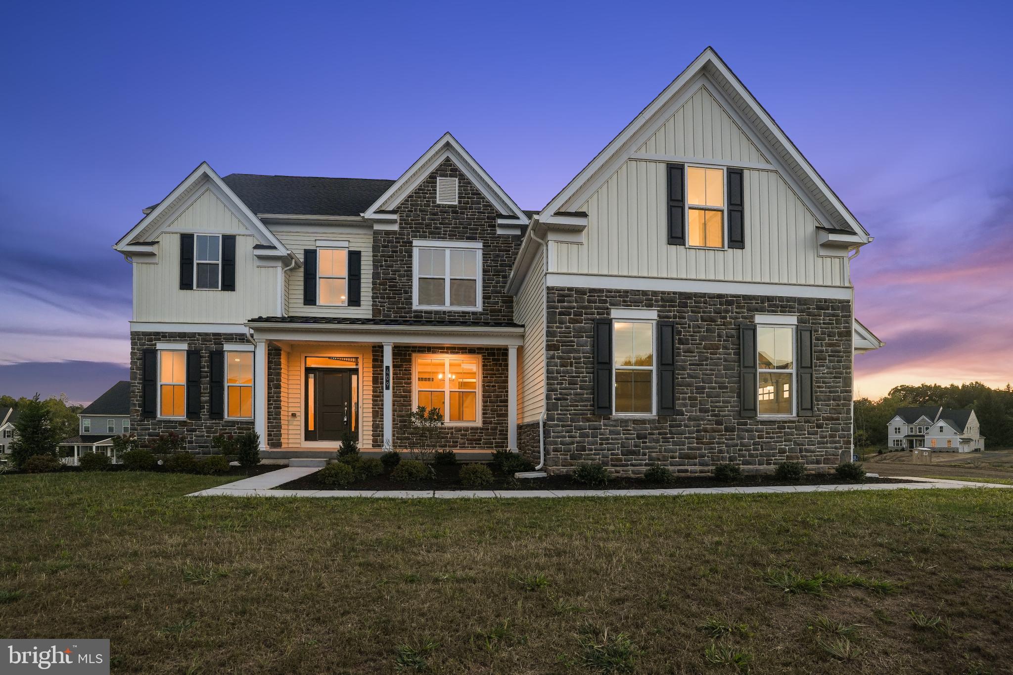 OPPORTUNITY! Sellers spent one year eagerly awaiting the completion of their dream home- only to be transferred for work. Their change is your advantage- this NEW residence is beautifully upgraded and perfectly positioned within the SOLD-OUT Meadows of Longview, in the highly acclaimed Spring-Ford School District. From the moment you arrive, the home makes a statement. A welcoming front elevation leads to a grand entry hall, where a sweeping curved staircase and extensive hardwood floors set the tone for the fine craftmanship throughout. Formal living spaces flow effortlessly - a sunlit living/sitting room perfect for quiet conversations and an elegant dining room with tray ceiling and butler's pantry, ready to host gatherings in style. The true CENTERPIECE is the two-story family room, a dramatic yet inviting space where soaring ceilings and a wall of windows frame natural light by day and a gas fireplace by night. The chef's kitchen is both stunning and functional, featuring fine cabinetry, a generous walk-in pantry, upgraded appliances, and show stopping quartz countertops. Whether it's a casual breakfast at the oversized island or preparing a holiday meal, this space is designed to inspire. A main floor bedroom and full bath offers flexibility for guests or at home office, while a well-planned mudroom and laundry room keep daily life organized and adjoin the three car attached garage. Upstairs, the owner's suite is a retreat in every sense. A spacious sitting room. two walk in closets, and a spa inspired bath with oversized shower, dual vanities, and upgraded tile create a private sanctuary. Additional bedrooms are generously sized (one with private bath, and two share a well-appointed attached bathroom- offering comfort for family and guests alike. A full daylight walkout lower level awaits your customization. Every detail has been thoughtfully curated, blending comfort, elegance, and function. With the community fully sold out, this is a rare chance to own a showpiece energy efficient property without the wait for new construction.