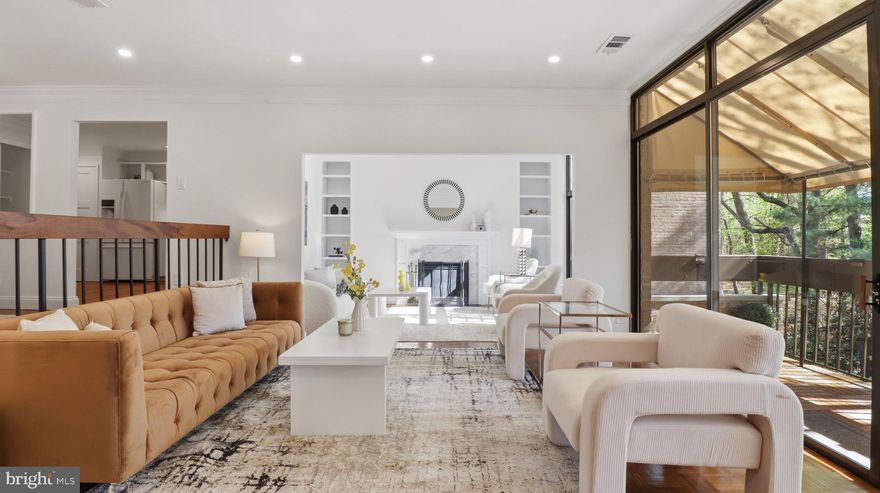 Welcome to 4924 Sentinel Drive #2-405 — a rare penthouse retreat in the sought-after Sumner Village community, where space, light, and privacy come together effortlessly.

This beautifully maintained 2-bedroom, 2-bath residence with a den offers 1,524 square feet of comfortable, flexible living. Soaring ceilings in the living room and den, paired with expansive atrium windows, fill the home with natural light and showcase peaceful, tree-top views with a desirable southwest exposure.

At the heart of the home, the living room opens to a large private balcony with new composite decking and a newer awning—perfect for relaxing or entertaining above the lush interior gardens. Just off the main living space, the spacious den features a wood-burning fireplace with custom built-ins, creating a cozy yet refined setting for a home office, reading lounge, or additional entertaining area.
The thoughtfully designed kitchen offers added privacy with a separate door, along with a built-in pantry and new beverage fridge. Throughout the home, you’ll find custom molding, recessed lighting, and Elfa closet systems that enhance both style and functionality.

The primary suite is a true retreat, featuring a walk-in closet plus an additional closet (a rare bonus), and a spa-like bath complete with a towel warming system. A second bedroom and full bath provide ideal space for guests or additional work-from-home needs. Additional highlights include a brand-new hot water heater (April 2026) and in-unit washer and dryer.

This unit conveys with two covered garage parking spaces—along with a large, secure storage unit on the garage level.

Set within Sumner Village, a 24-hour gated and Certified Wildlife Community, residents enjoy a full suite of amenities including a swimming pool, fitness center, tennis and pickleball courts, grilling area, and library. The location offers direct access to the Capital Crescent Trail, is adjacent to Metro and Ride On bus service, and is just steps to the Shops at Sumner Place—delivering the perfect balance of convenience and tranquility.

A rare opportunity to own a light-filled move in ready penthouse with exceptional privacy, generous space, and an unbeatable location.