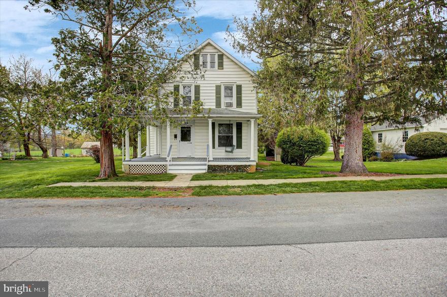Discover the perfect blend of historic character and modern reliability in this spacious Colonial located in the heart of the Borough of Mercersburg. This home boasts impressive high ceilings and large, airy rooms that are filled with natural light. You can move in with peace of mind knowing the heavy lifting has been done, featuring updated windows and electrical wiring. The interior showcases beautiful hardwood floors across both levels, leading you through a formal living room, a separate dining room, and a functional kitchen equipped with appliances. Upstairs, you’ll find three generous bedrooms and two full baths. Situated on a rare .41-acre double lot (comprised of two deeded parcels (14-3A11.-006 and 14-3A11.-007), the property offers expansive outdoor space with peaceful farmland views directly behind the home. Enjoy the efficiency of natural gas heat and the potential to build equity.  Don't miss this opportunity to own a piece of Mercersburg with room to grow!