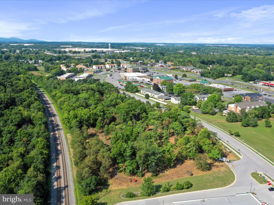 Brush recently cleared and land cleaned up. Incredible opportunity to purchase land in the Growing Courthouse Square Section of Martinsburg. New townhome subdivision has just been approved for 173 units one block from this lot. This is considered the Business District of Martinsburg and the city is behind responsible growth in this area. Zoned for Mixed Use Commercial, there are multiple uses that can be permitted including, but not limited to retail, professional office, storage, flex space, sales, banking, and more. Lutz Ave is fully paved and improved with sidewalk installed. Some Owner Financing may be available for a first trust position depending upon plans and building use.