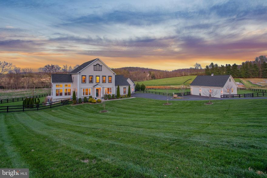 Enchanting. That's the word that describes this very special property. Private, serene and picturesque, it's the perfect house to spend quiet time with family, but its versatile design is also fabulous for hosting big, festive gatherings!

Located on a quiet cul-de-sac in highly sought after Waterford Manor, this gorgeous home on 4.72 acres is offered for resale for the first time. Enjoy the Waterford lifestyle in this fabulous 6 bedroom, 4 full/2 half bath home complete with custom upgrades throughout, an oversized 3-car detached garage with space above that could be finished, and incredible outdoor living! Pride of ownership shows in this better-than-new, 6-year-young house and property. 

With an open and inviting floor plan, this home offers a seamless flow throughout the main level, featuring an eat-in gourmet kitchen with upgraded cabinets and stainless steel appliances, including two wall ovens, gas cooktop, built-in microwave, trash compactor and more. The kitchen is open to the breakfast nook as well as the cozy family room which is adorned with exposed beams and beautiful stone fireplace, perfect for entertaining guests or family gatherings. And when you're ready to snuggle up to read your favorite book, the lovely vaulted sunroom is the perfect place to unwind.

Incredible attention to detail and custom touches are found throughout this lovely home. From the full-wall wood wine display in the dining area to the elegant wine enclave with brick flooring and glass door, to the custom office doors, to the brick feature wall in the basement bar, this home is dressed to impress!

At the end of the day, take one of the most beautiful drives in Loudoun County up Loyalty Road to come home and relax in any one of several amazing outdoor living spaces, including the romantic balcony off the primary bedroom, the covered deck, or the beautiful patio, complete with gourmet outdoor kitchen, hot tub, sauna, wood-burning fire pit and gorgeous views of the surrounding landscape. Take in the tranquil sounds of the natural spring with a small water feature and charming bridge, or let the kids have fun in the tree fort and zip line or on the fabulous sledding hill! And there's plenty of space for a pool in the level, fully fenced backyard.

Other fabulous features include: Generac generator; Xfinity high-speed internet; security system, high-end double water filtration system; whole home air purifier; and a secret door to the playroom/hobby room!

This home is truly a masterpiece with attention to detail at every turn. Don't miss out on the opportunity to make it yours and experience the luxurious lifestyle you've been dreaming of! Zoned for Waterford Elementary School.  Security cameras onsite. Do NOT drive down driveway without an appointment.