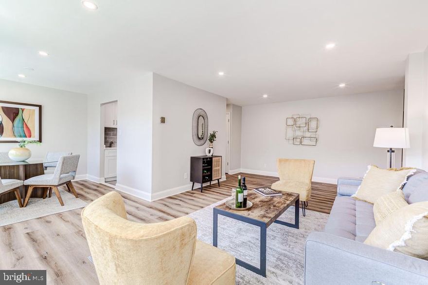 **PRICE REDUCED!!**Sought-after Falls Church City location, 1/2 mile walk to Metro, impressive $65,000 unit renovation just completed!**  Light & bright living spaces great guests with a cool grey color palette and LVP flooring throughout.  Seriously spacious, this unit has room to seat 5 comfortably at both the dining table and in the living room; a great spot for your next dinner party! Recessed lighting helps brighten the unit any time of the day.  The kitchen has ample storage with beautiful soft-close cabinetry, plus a separate pantry! Stainless appliances, quartz counter tops, and a textured subway tile back splash help make this a great place to cook.  The primary suite features a glass walk-in shower with on-trend tile-work throughout.  Down the hall, find a secondary bedroom, and main bath, also fully improved.  Don't miss a cavernous amount of in-unit storage, find two over-sized storage closets on the main hall, and a walk-in coat closet in the foyer.  For those who have lived in a condo before, you'll appreciate that all HVAC convectors were installed last year.  Extensive plumbing work, the kind you can't easily see, has also been completed inside the unit, to allow for total control shutting off water fixtures inside the unit, along with the addition of a main-water shut-off.  The Madison is pet friendly, with a wonderful staff, and well-kept grounds. There is a penthouse party room for residents to use, with a serving bar, multiple seating areas, and a huge TV -- a great place to host your own game day party!  Outside, is plenty of unassigned parking for residents and guests, plus a BBQ and picnic area.  Metro bus is right in front of the building, and the East Falls Church Metro station is a half-mile away, connecting you to countless destinations in DC and around the DMV.