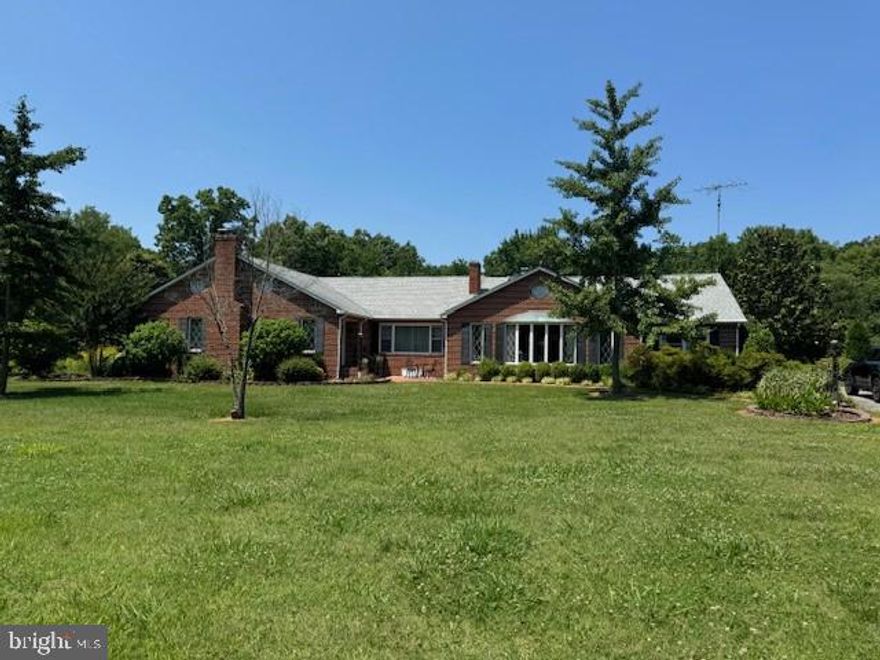 All-Brick Rambler on a 6.11 acre lot along with a 9.58 acre separate lot with potential for additional homesite.  This price includes both lots 

Welcome to 21500 Point Lookout Road, Leonardtown! This  all-brick rambler sits on a large extensively landscaped lot and offers over 3,600 sq. ft. on the main level, plus 1,200 sq. ft. in the partially finished lower level. The home features 3 bedrooms (including 2 primary suites, one with fireplace), 3 full baths on main level, 4 wood burning fireplaces, a country kitchen with a keeping room features one wood-burning fireplace, a formal living room, and a large family room each with their own fireplace. Office space and workshop also on main level. The lower level includes a full bath, office, and rec room.  A serene location with extensive landscaping that backs to trees.  Easy access to St Mary's Lake!!   

Key Features:
Bedrooms & Bathrooms: 3 bedrooms, 3 full baths on the main level; 2 primary suites and laundry in main primary bedroom.
Living Spaces: Formal living room and large family room, both with wood-burning fireplaces.
Country Kitchen: Includes a keeping room with a wood-burning fireplace.
Lower Level: Partially finished with full bath, office, and rec room and laundry
Garages: Attached two-car carport and two detached garage/workshop spaces.
Land & Landscaping: Extensive landscaping on 15 acres with potential for subdivision; ample parking off paved driveway.
This property offers a unique combination of spacious living,  and development potential in a prime location!!