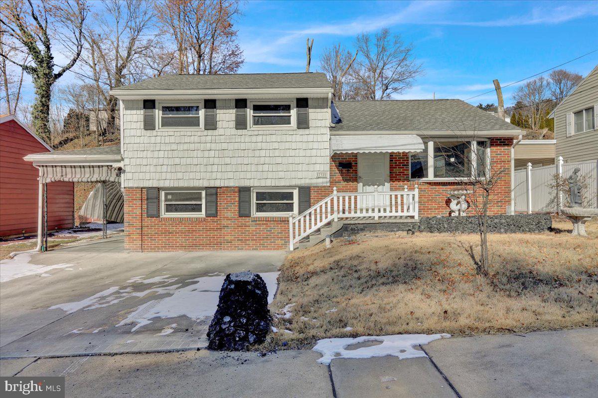 New flooring and paint in this 4 bedroom, 2.5 bath split. Large room sizes. Additional lot in rear with separate garage accessed from upper street.
