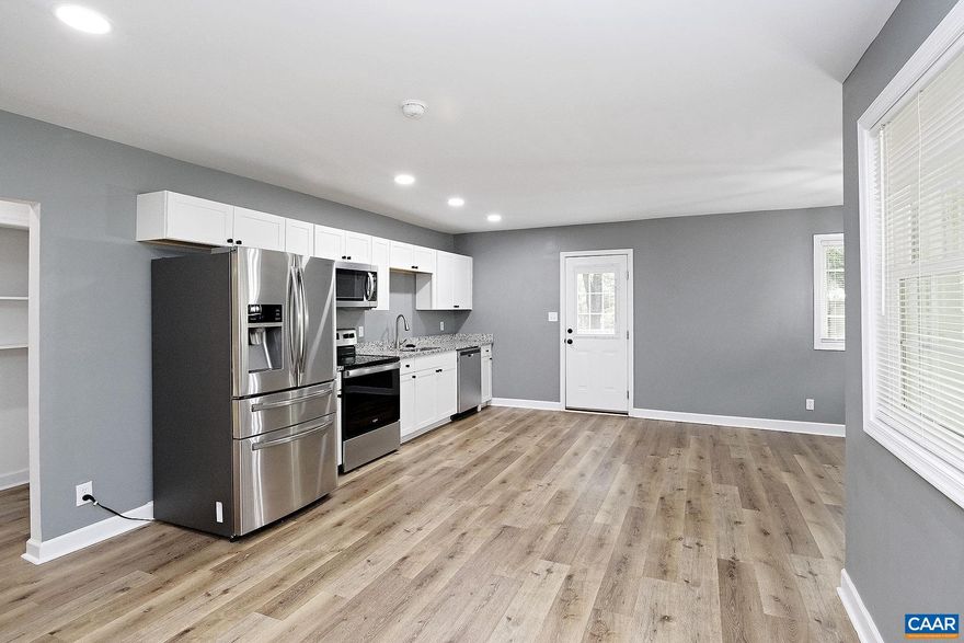 For a limited time, enjoy $25 application fees! This pet-friendly 3 bedroom, 2 bath home has been nicely renovated and is located on over 3 acres in Northern Albemarle county. The 2,242 square foot residence is conveniently located within a 10-mile radius of the Charlottesville-Albemarle Airport, Hollymead Town Center, UVA's Northfork, and Rivanna Station (NGIC/DIA). Outdoor enthusiasts will enjoy living just minutes from Preddy Creek Trails.  The main floor features an open living room that flows into the kitchen, with granite countertops and stainless steel appliances, and a dining area. Durable luxury vinyl flooring is found throughout this level. The primary bedroom includes a walk-in closet and a private, full bath with a tiled shower. Two additional bedrooms share a full hall bath, and a bonus space outside the primary bedroom is ideal for a sitting area or office.  A finished basement provides versatile space for a family room or entertainment area, and a laundry closet (washer, dryer, utility sink) is included. Outside, you'll find a side deck for relaxing and a convenient wrap-around driveway. Up to two pets (100 lbs max, combined) are allowed with fees.