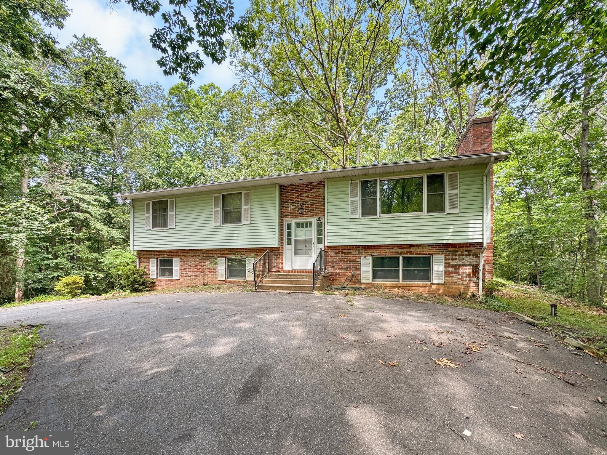 This spacious, 2600+ SQFT split foyer offers serious potential for the buyer ready to make it shine. Situated on a full acre on a quiet, no-thru street, this property provides privacy, flexibility, and the rare chance to build instant equity through cosmetic updates.
Inside, you will find a large main-level layout featuring an oversized kitchen with ample cabinet space and natural light. The lower level has its own entrance, second kitchen setup, and two additional rooms, creating possibilities for multigenerational living, rental income, or an in-law suite. Two impressive fireplaces add warmth and character to the home
Structurally, the home presents well and is a strong candidate for FHA 203k buyers, long-term investors, or flippers looking for their next project. With a few updates, this property can quickly become a high-value asset.
Outside, the oversized detached garage with high-clearance doors offers exceptional storage for vehicles, tools, or a home workshop. The setting is peaceful and unrestricted—no HOA and surrounded by trees—yet still accessible to local amenities.
This is a rare find with room to grow, renovate, and reap the rewards. Do not miss your chance to turn potential into profit—schedule your showing today.