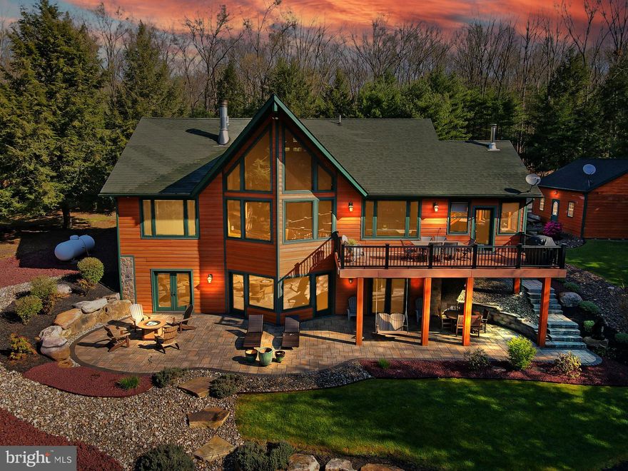 Discover the epitome of luxury and privacy at this stunning private retreat, sprawling across nearly 35 acres in the Beltzville State Park area. Conveniently located near the Route 476 exit and just 20 minutes from Blue Mountain and Big Boulder Ski Areas, this property offers an unparalleled escape. As you travel down the long, fully paved driveway, you’ll immediately appreciate the seclusion and tranquility that await. Upon arrival, be greeted by breathtaking views of the immaculately landscaped property and your own 2-acre pond, complete with a central island and a dramatic mountain backdrop. The serene White Oak Creek meanders through the property at the mountain's base. Plenty of space for toys with 4 car AND 2 car detached garages. This isn’t your typical hunting or ski lodge. The home boasts numerous exceptional features, including high-end granite countertops in the kitchen and bathrooms, which also have heated floors for added comfort. The A-framed great room with its 20-foot high ceiling, exposed wood beams, and expansive windows, offers stunning views of the pond and mountain. The unique Australian Acacia hardwood floors in the great room, kitchen, and loft add natural beauty, while the efficient geothermal heating and cooling system keeps the 4,300+ sq ft home comfortable year-round. Stand alone 20KW Generac generator with owned 500 gallon propane tank. The 28x12 composite deck overlooking the pond is perfect for grilling and entertaining. Very reasonable taxes.