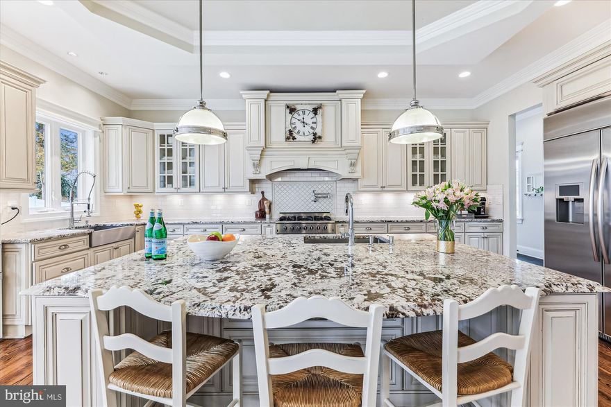 *Don't miss this *SPECTACULAR* 8 BR/5.5BA craftsman, just a few blocks from the center of McLean!  Boasting approx. 8100  finished square feet, this finely detailed and expansive home features 3 finished levels of naturally bright open floor plan design with 10 ft. ceilings and a beautiful 2-story foyer. The main level includes beautiful hardwood flooring throughout; the formal dining room and light-filled living room are just off the entry foyer. Continue to the heart of the home with a spacious family room featuring gas fireplace, coffered ceiling and a wall of windows allowing amazing light through the day.  The gourmet kitchen is a chef’s delight, highlighting high-end appliances, an oversized island with sink and bar area, granite countertops, additional farmhouse sink, and custom cabinetry.  A butler’s pantry with a wine refrigerator adds convenience to your culinary experience. The breakfast area is open to the kitchen and family room, with access to the rear deck area overlooking the private backyard. Additionally, there is a guest suite/office with built-ins on the main level, providing convenience and flexibility. Completing the main level, next to the kitchen, find a convenient mud room area with built-ins and 2 large walk-in pantries. Step from the mudroom to 2 separate garages - one with single parking space and EV charging station and the second, with 2 parking spaces - both with ample storage space.  On the upper level, the sprawling owner’s suite steals the spotlight, complete with a gas fireplace, sitting area with built-ins, separate room with large dressing area and 2 huge walk-in closets. The luxurious en suite features a stand-alone clawfoot cast-iron bathtub, spa-like walk-in shower, and two separate vanities. The large hallway with 4 additional generously-sized bedrooms include two big jack-and-jill bathrooms - both with dual vanities. Laundry is also located on this level with cabinets, sink, and countertop space. The lower level adds to the allure of this inviting residence with a spacious recreation room, wet bar, media room, exercise room and 2 additional spacious bedrooms – one with built-ins and en suite with soaking tub.  Outside, a gorgeous stone-walled walk-up leads to the level backyard. EXCELLENT location in the heart of McLean - walk to grocery store, restaurants, schools!  Franklin Sherman, Longfellow, McLean schools!