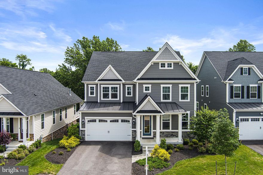 Stunning former NV model home loaded with upgrades and in "like new" condition situated on a premium lot backing to a treed area that borders the golf course. High quality flooring throughout the home with an open floor plan that brings in tons of natural light. The main level features French doors leading into the main level study, a separate formal dining room and a gourmet kitchen with a spacious center island, top of the line appliances, tiled backsplash as well as a large walk-in pantry and custom built-in cabinetry.  The kitchen is open to the large family room with access to the covered porch that featured a stone gas fireplace with lights, combining the warmth and ambiance of a traditional fireplace with modern lighting. The second floor is home to an open loft as well as 4 generously sized bedrooms, three full baths and laundry room. The luxury primary suite is highlighted with a tray ceiling, a spa like bath featuring dual vanities and a large soaking tub and two large walk-in closets. The finished lower level offers a full bath with French door walkout to the rear patio. The HOA fee covers all lawn care and mulching. Underground sprinkler system in both front and rear. Wired for outdoor landscaping lighting. Security system. Outlet in garage for EV. Pool and tennis memberships available at Turf Valley Country Club.