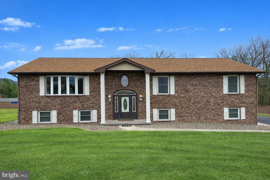 Rare Opportunity! Beautifully maintained split foyer on a double lot totaling 1.52 acres in a desirable subdivision—featuring an incredible climate-controlled 52x52 detached garage capable of housing approximately 14 vehicles with RV access and three vehicle lifts. A dream setup for collectors, hobbyists, or anyone needing serious garage space! Step inside the home and you’re welcomed by a stunning entryway anchored by a crystal chandelier imported from Germany. The main level offers a bright open-concept layout with a spacious living room, dining area, and an impressive gourmet kitchen featuring solid oak cabinetry, granite countertops, gas cooktop, double ovens, a massive island, breakfast nook, and abundant storage. The primary suite is a true retreat with a spacious bedroom, two walk-in closets, and a luxurious bath with walk-in shower, double vanity, and tile flooring. Two additional bedrooms on the main level also feature large walk-in closets, and the hall bath includes a double vanity. The finished lower level offers fantastic entertaining space with a wet bar with icemaker and granite counters, dining area, gas fireplace, fourth bedroom, full bathroom, and a mudroom/laundry room with access to the attached two-car garage. Enjoy outdoor living from the gorgeous covered composite deck overlooking the yard or relax on the covered patio below. The side and rear yard are enclosed with a composite privacy fence, and the paved driveway provides easy access. Additional features include gas forced-air heating, central air, and a generator for added peace of mind. A property like this—combining a spacious home, large lot, and an extraordinary garage setup—rarely comes along!