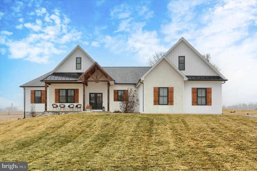 Discover refined country living at 23 Peyton Dr, a 2022 custom‑built home located in Carlisle’s desirable Lindenwood community. Set on nearly 2.5 acres, this property offers exceptional privacy, sweeping panoramic views, and unforgettable sunrises and sunsets—all just minutes from town.
Designed for effortless one‑floor living, the main level features an expansive great room with 10‑foot ceilings, a tasteful two‑toned gourmet kitchen with a hidden walk‑in pantry, a dining area, and a roomy family room. The spacious primary suite includes a tray ceiling, a beautifully designed bathroom, and a large walk‑in closet. Three additional bedrooms and a full bath complete the main level.
Offering almost 3,000 square feet of finished living space, this home also includes a versatile bonus suite above the garage with its own full bath—ideal for guests, a home office, or a recreation area. And the full walkout basement provides abundant potential for future expansion.
Outdoor living shines with a generous covered patio and extended deck overlooking the picturesque landscape with attractive fencing, and residents enjoy access to the neighborhood’s paved walking path.
Experience peaceful country living without sacrificing convenience. This exceptional property is ready to welcome you home. Schedule your visit today!