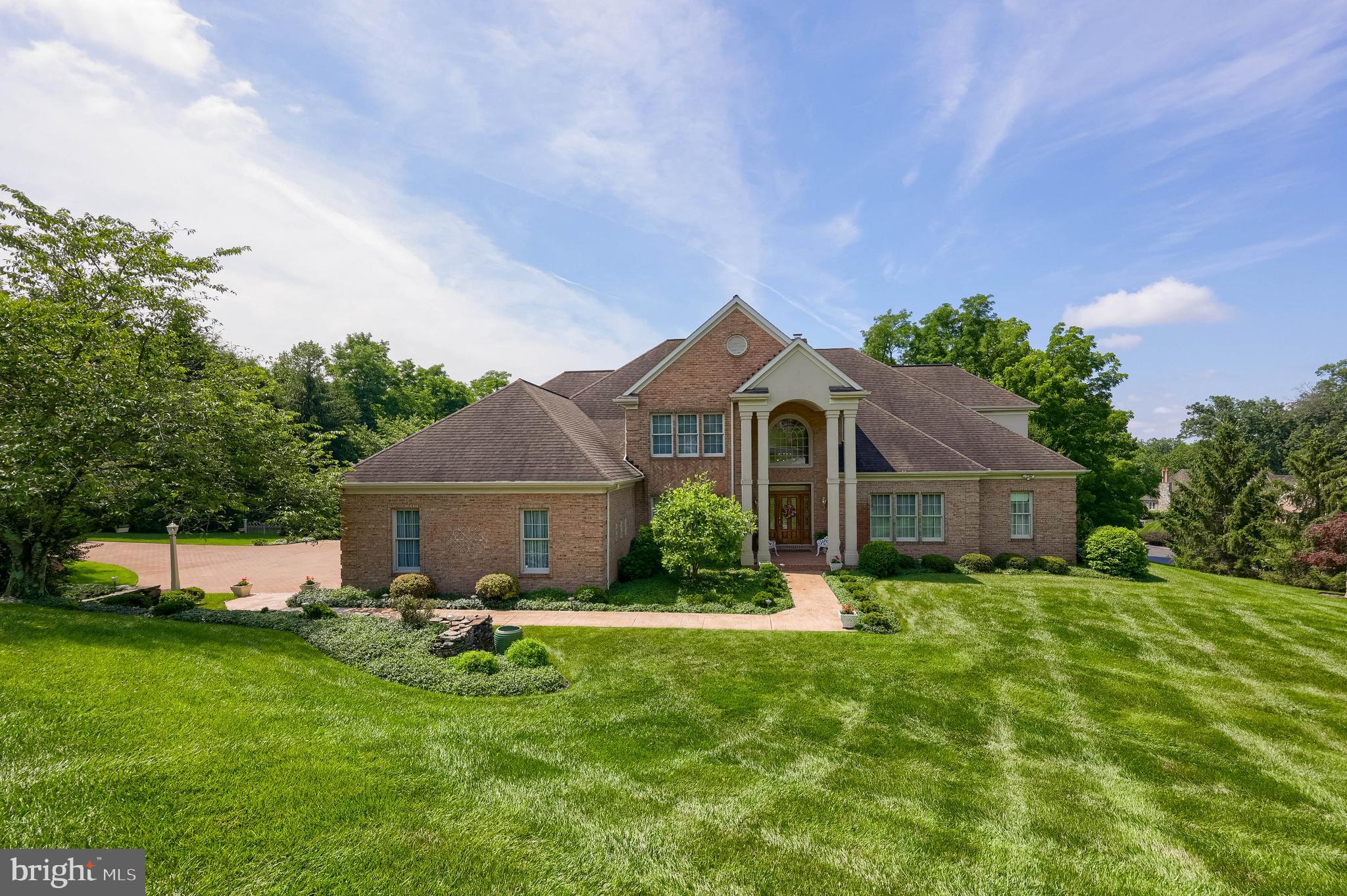 Experience timeless elegance in the Wyndham Hills South community, where privacy, space, and sophistication converge. Designed in collaboration with the award-winning architecture and planning firm Murphy & Dittenhafer, this exceptional residence offers a rare combination of tranquility and grandeur, with no through traffic and low-maintenance living. A two-story foyer welcomes you with an abundance of natural light, complemented by a home office featuring built-in cabinetry, a formal dining room adorned with wainscoting, french doors, and hardwood floors, perfect for entertaining. The heart of the home is the stunning two-story great room, featuring soaring vaulted ceilings and a striking wood-burning fireplace with a gas starter. The spacious kitchen is both stylish and functional, boasting a center island, rich cabinetry, and an inviting breakfast room. The main level is anchored by an expansive primary suite, your private retreat, complete with a gas fireplace, access to a serene patio, two generous walk-in closets, a luxurious en suite bath with jetted tub, stall shower, dual vanities, a separate sitting area ideal for dressing or relaxing, and a bonus room. This level also includes two convenient powder rooms and a laundry room. Upstairs, three well-appointed bedrooms and two full bathrooms, including a Jack and Jill layout, provide comfort and privacy. A loft overlooks the great room and foyer, while a large storage room offers ample flexibility. The finished lower level is designed for fun and function, featuring a recreation room with half bath, a dedicated exercise room, and a large unfinished area ready for your vision. Outdoor living is equally impressive, with a pergola, both covered and open patio spaces, a peaceful pond, and a fenced, level yard, perfect for relaxing, entertaining, or play. Situated on a one acre lot, the property also features a three-car oversized garage and parking for five additional vehicles in the driveway. This home is a rare opportunity to enjoy space, comfort, and refined design all in one beautifully crafted property. Do not miss the opportunity to acquire this exceptional residence; contact us today to schedule a private tour.