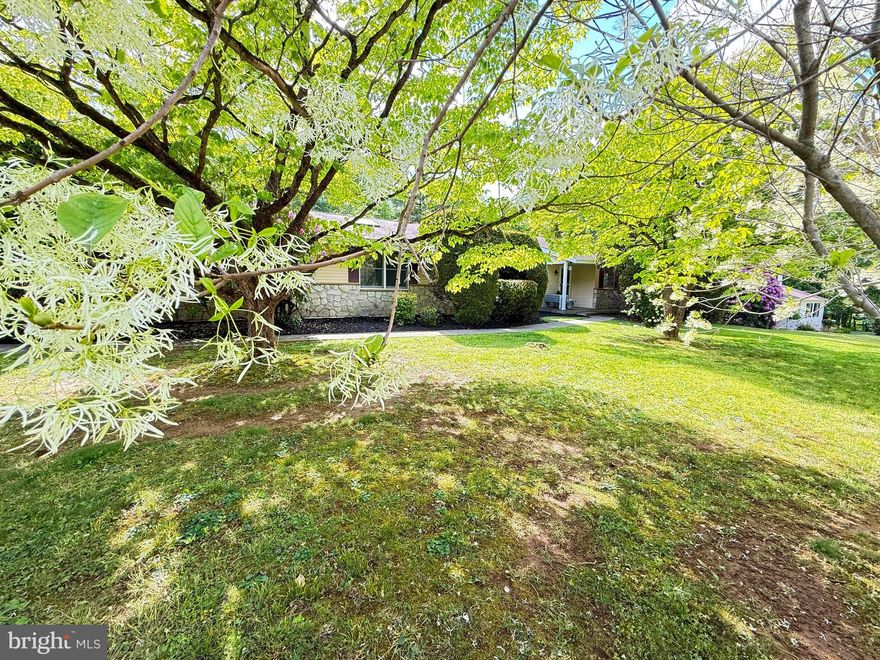 Welcome to this Garnet Valley Home Sweet Home! This is your chance to own a charming ranch home situated on 1 picturesque acre with endless potential.  Enjoy a parklike setting highlighted by amazing flowering trees, perennial gardens, and roses, all backing to peaceful woods for added privacy.
Step from the covered front porch into the welcoming foyer and continue into the spacious formal living and dining rooms, perfectly open to the kitchen and breakfast room featuring a cozy brick wood-burning fireplace and sliders to the back deck that fill the space with natural light. The kitchen offers plenty of pantry space, along with the convenience of a main floor laundry room and powder room. An additional rear entrance provides easy access to the level backyard.  HARDWOOD FLOORS THROUGOUT most rooms!
One of the standout features is the AMAZING family room complete with a large skylight, ceiling fan, hardwood floors, and direct access to the attached 2-car garage.
Retreat to the primary bedroom featuring a ceiling fan, two closets, and a newer full bath with stall shower. Two additional bedrooms and a hall bath with linen closet complete the main level.  All Bedrooms with Hardwood Floors.
The large walk-out lower level offers a blank canvas ready for your imagination — perfect for a theater room, game room, workshop, 4th bedroom, or additional storage space.
Additional highlights include newer HVAC (2022) and an unbeatable location in the Award-Winning Garnet Valley School District.
Convenient to EVERYTHING and EVERYWHERE — with easy access to Philadelphia and Wilmington Airports, NJ, DE & MD beaches, and tax-free shopping just minutes away in DE.  Nearby attractions include Glen Eagle, Brinton Lake, Concordville, Brandywine Shopping Centers, Costco, Wegmans, Whole Foods, Longwood Gardens, Wilmington museums, outstanding restaurants, Main Line Health, Penn Medicine, and Penn Woods & Chadds Ford Wineries.  
Concord Township is ready for summer fun — don’t miss your opportunity to own this SWEET HOME! (Few Photos are virtually enhanced for staging purposes)