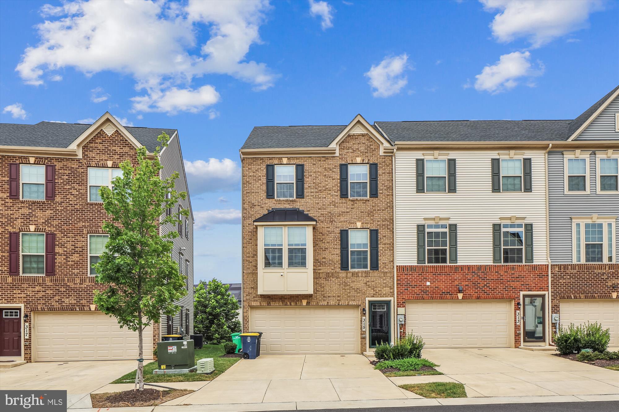 Welcome to 315 Southwind Drive. This property is a stunning end unit, three-level townhome spanning over 2,700 sqft. It features an open floor plan with a upgraded gourmet kitchen, including white linen cabinets, a large 10+ ft island, white quartz countertops, carrara marble backsplash, double oven, cooktop stove, and all stainless steel appliances. The home boasts black fixtures, elegant edging, and hinges throughout, along with wide plank flooring and wood stairs with white risers. Upstairs, there's a laundry room with a window, equipped with black Samsung washer and dryer. The end unit offers additional windows, enhancing natural light. The primary bathroom includes a soaking tub and shower, while the dining room features a charming box bay window. The attached two-car garage, recessed lighting, and a 20x10 Trex composite deck add to the appeal. Landscaping is included in the HOA fee. Community amenities include a clubhouse, tot lots, playgrounds, multi-sport court, and a prime location just 15-20 minutes from National Harbor, MGM Casino, and outlets, with easy access to DC and VA in about 25 minutes.