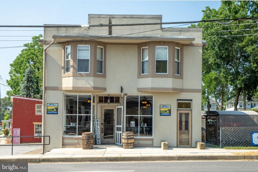 THIS IS YOUR CHANCE FOR VISIBILITY...CORNER BUILDING AT ALT.40 & BALTIMORE (MAIN) STREET FUNKSTOWN! REAL ESTATE ONLY FOR SALE - 2 UNIT BLDG WITH MAIN LEVEL STORE FRONT COMMERCIAL UNIT W/RESTROOM AND UPPER LEVEL RESIDENTIAL 3 BR/2 BA UNIT. THIS PROPERTY INCLUDES THREE (3) ADDRESSES - 115, 117 119 E. BALTIMORE STREET, FUNKSTOWN AND HAS ACCESS FROM BALTIMORE STREET, PUBLIC PARKING LOT AND IN THE REAR ON MAPLE STREET. (CHECK OUT THE PLAT IN DOCUMENTS) - INCLUDES DRIVEWAY FROM MAPLE STREET, GARAGE FACING MAPLE STREET, SIDE YARD WHERE OUTSIDE SEATING CURRENTLY EXISTS, STORAGE BUILDING, THREE LEVEL BUILDING WITH 2 UNITS AND FULL BASEMENT. MAIN LEVEL UNDERWENT FULL RENOVATION IN 2024 NOW OPERATING AS A WINE TASTING ESTABLISHMENT & WINECRAFTER'S  PRODUCTION. UPPER RESIDENTIAL UNIT COULD BE RENTED (AS IS CURRENTLY) FOR INCOME OR AS THE OWNER'S RESIDENCE. SOOO MANY POSSIBILITIES ... THE PROPERTY IS WELL-MAINTAINED, UPDATED AND READY FOR YOU TO IMMEDIATELY MAKE THE MOST OF THIS OPPORTUNITY! IF YOU MIGHT HAVE INTEREST IN THE EXISTING BUSINESS, THE OWNERS CAN DISCUSS, BUT NOT INCLUDED IN THIS OFFER PRICE. WOULD BE PERFECT FOR SO MANY RETAIL OPERATIONS INCLUDING WINERY, BREWERY, FOOD/BEVERAGE SERVICE - ALL ABSOLUTELY TURNKEY. MANY COMMERCIAL USES ALLOWED.