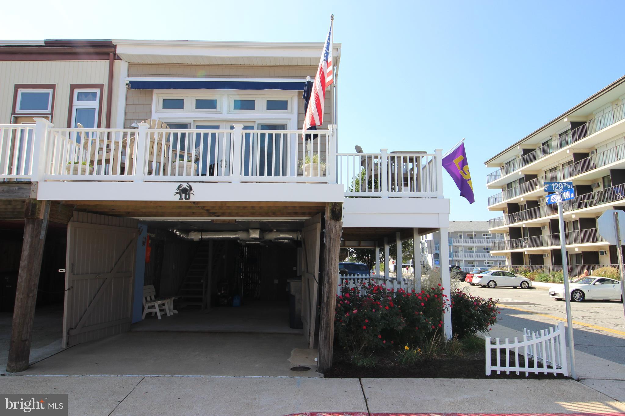 One of a kind! FEE SIMPLE 3 bedroom 2 bath townhome. Completely renovated, NO HOA fees. Unique three levels with 1st floor garage. Located on 129th street quiet north OC location with ocean views. End unit with wrap around balcony recently added. New trek deck, electric awning. First floor has large full sized Dryer, LOTS of storage area, can fit one car in garage. Up the stairs to the second floor is a completely renovated eat in kitchen with Corian counters, breakfast bar, Stainless appliances and combo washer/dryer. Open floor plan flows into large living area with vaulted ceilings. All new solid panel interior doors and stainless hardware. All new vinyl clad windows. Double slider off living room opens to large wrap around deck with ocean views. Steps to the quiet beach at 129th Street. Conveniently located off back of kitchen is a nicely appointed bedroom with full bath and double bunk. Upstairs on third level is a large Master Bedroom with vaulted ceilings two closets with plenty of storage, renovated bathroom with new tile, granite, fixtures, opens up to third bedroom with futon bunk. Close to shopping, restaurants, Northside Park. Totally turn key.